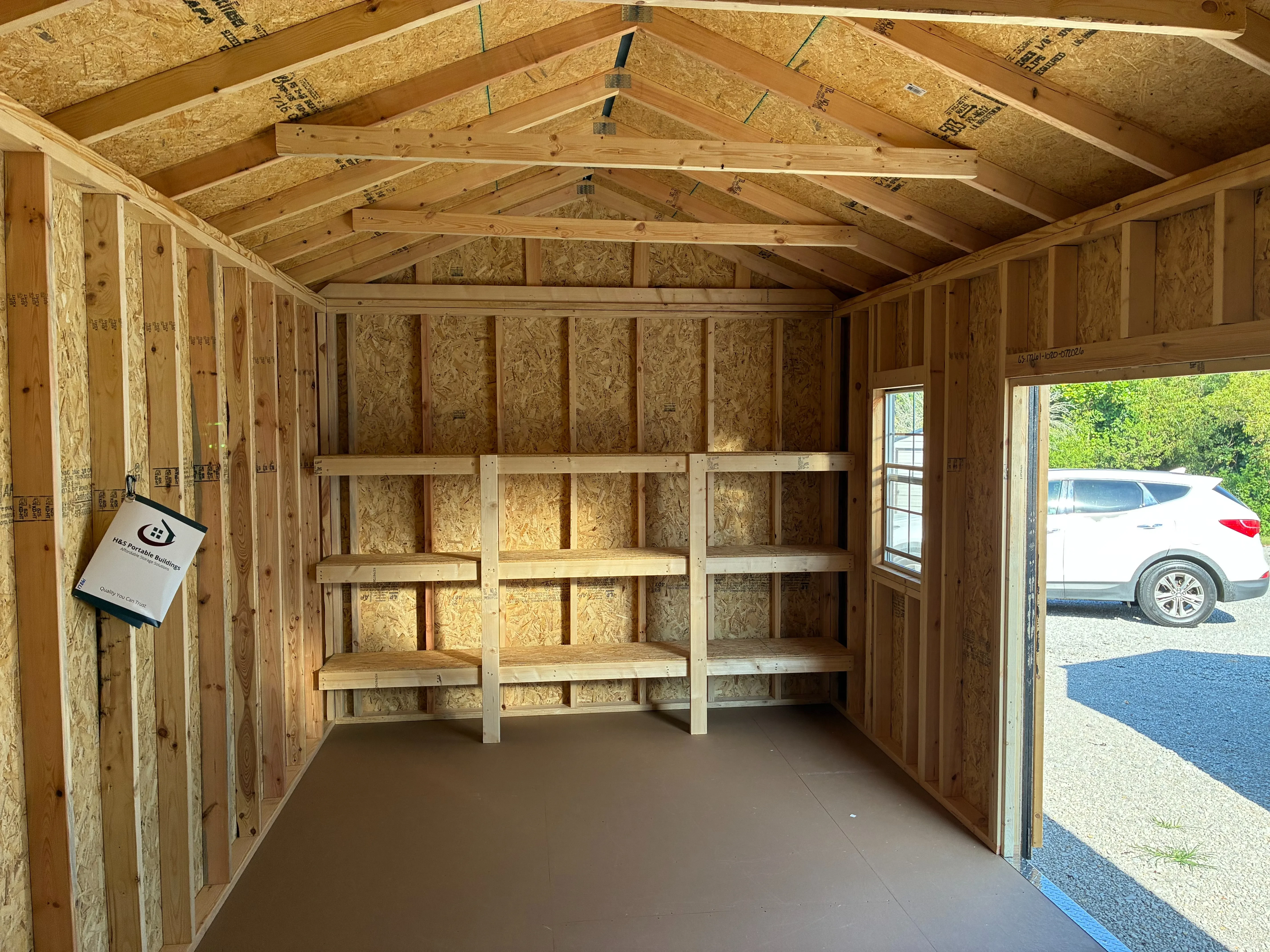 interior 10x20 garden shed showing 3-tier shelving