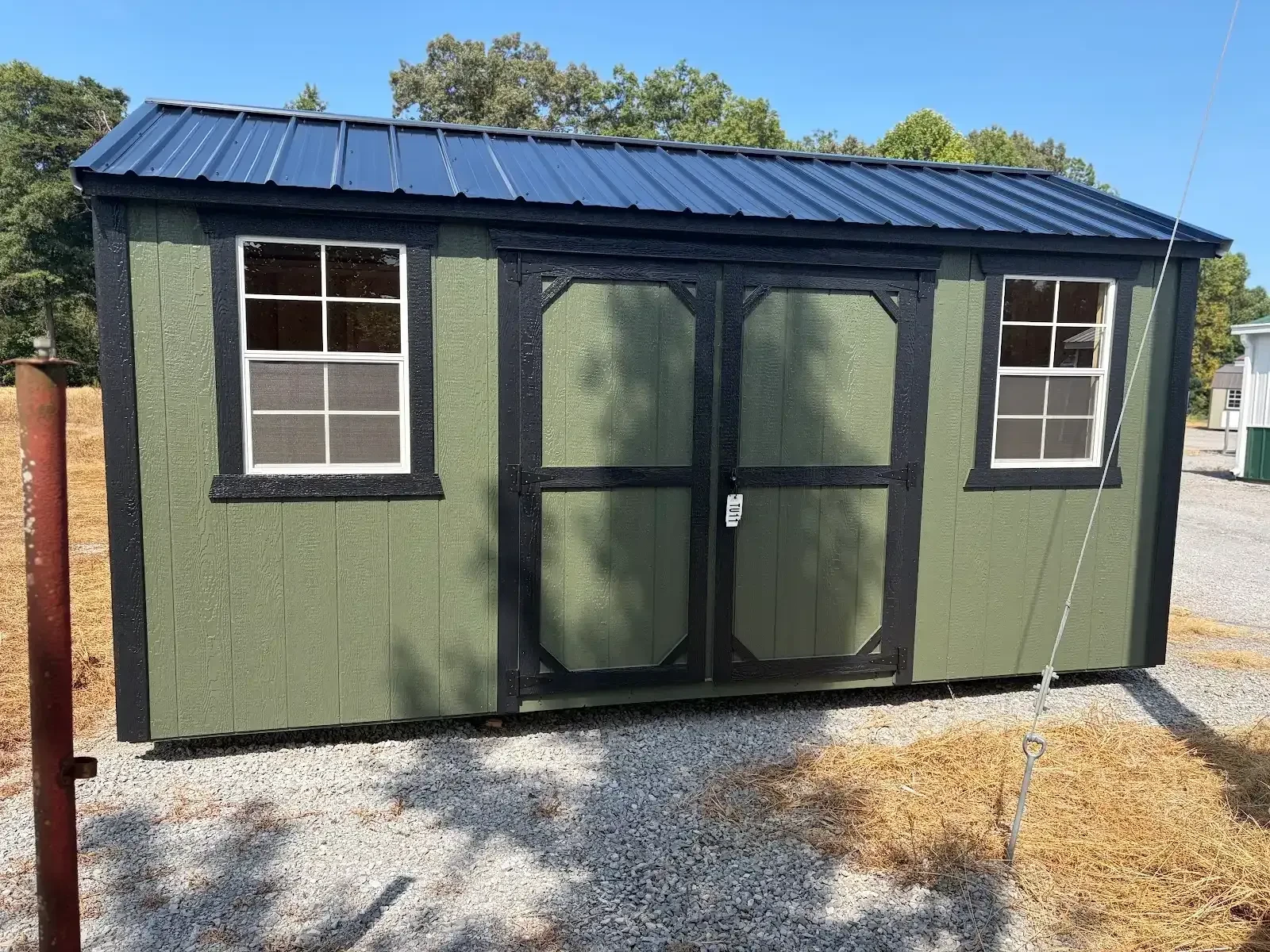 exterior view garland green siding, black roof & trim double doors, windows