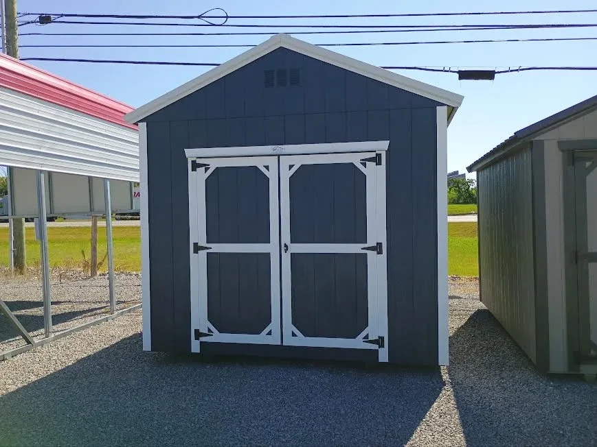 Outside of 10x12 classic wood utility shed with double doors, painted wood, and metal roof.