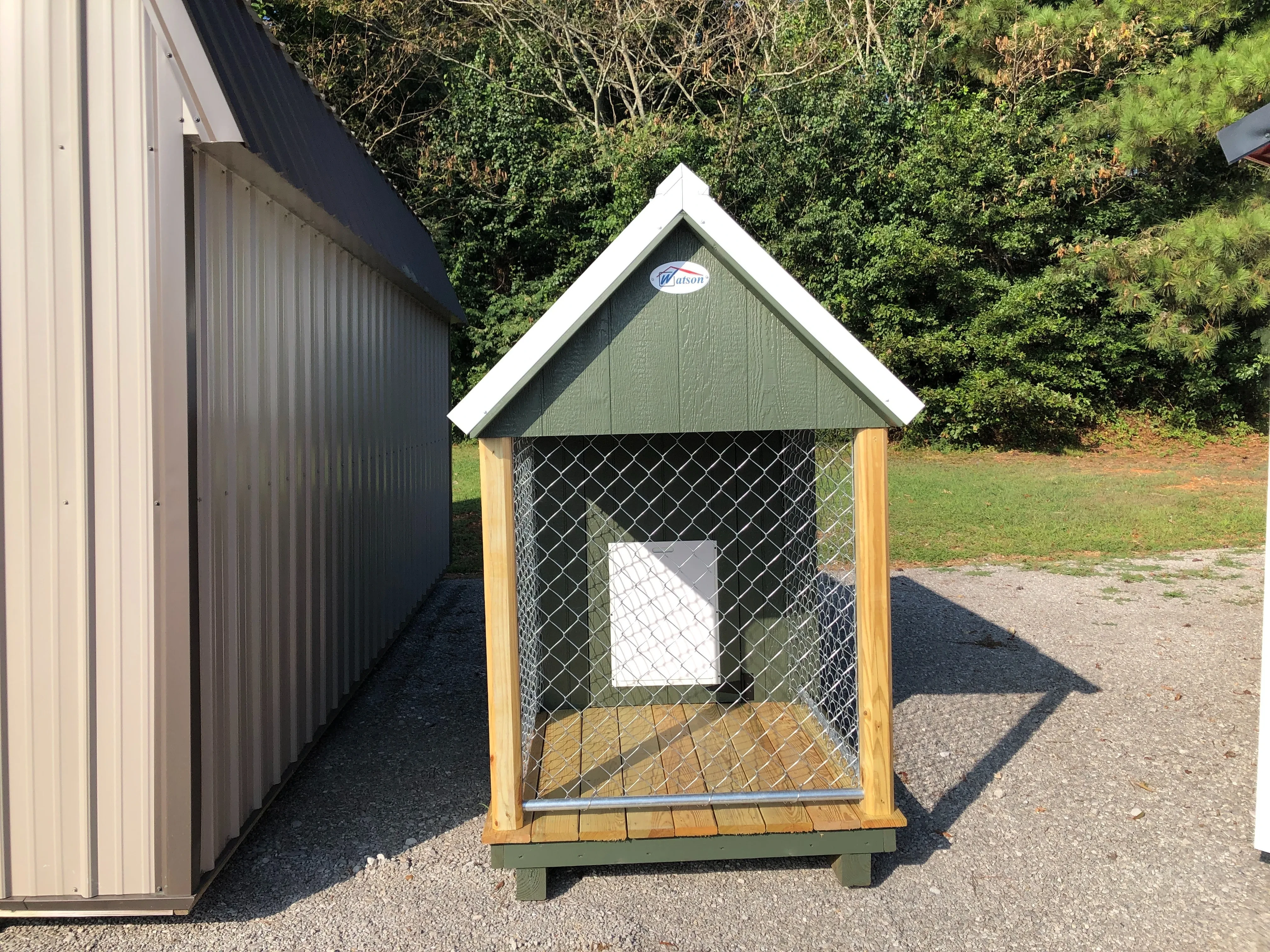 small dog kennel showing the doggie door and chain link run