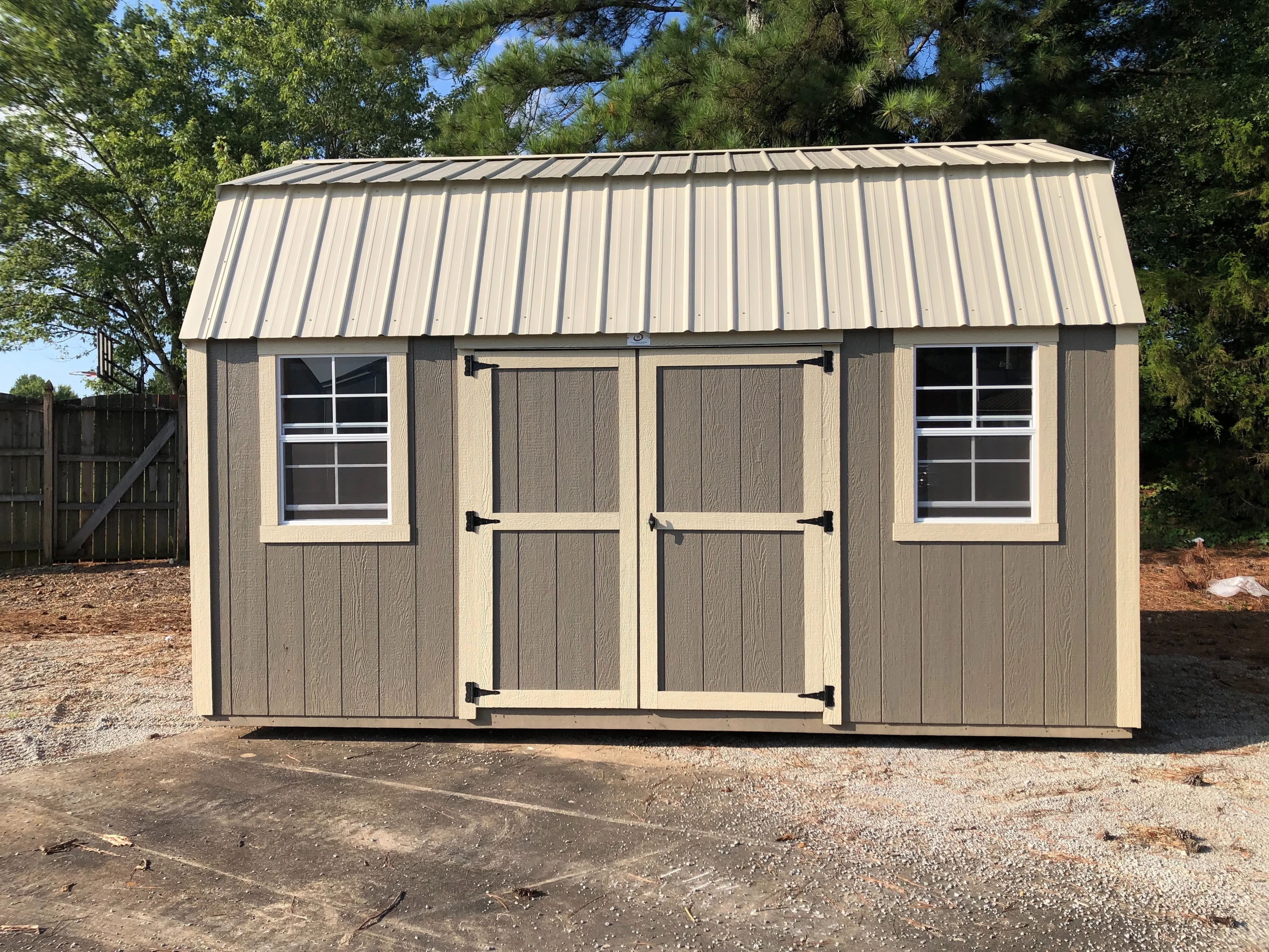exterior of 10x16 side lofted barn showing windows and door