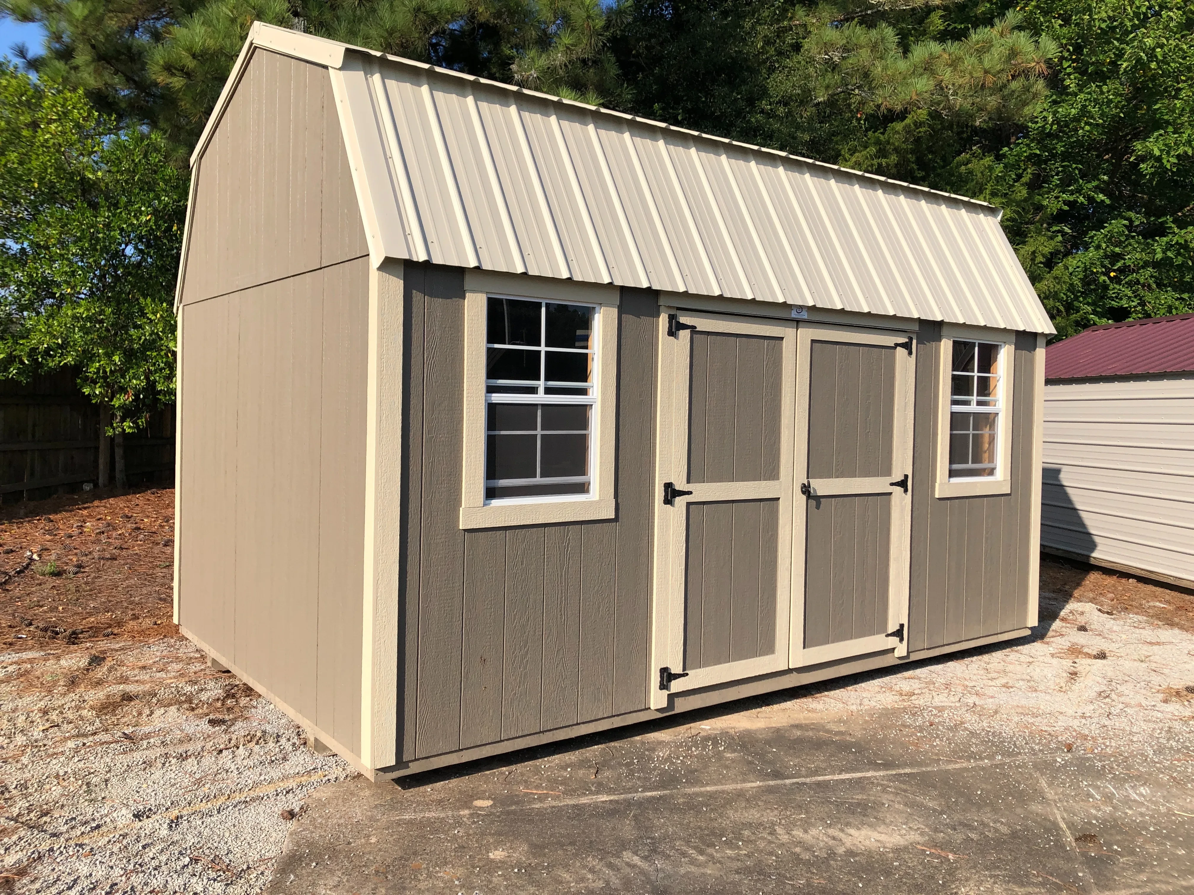 exterior of 10x16 side lofted barn showing windows and door
