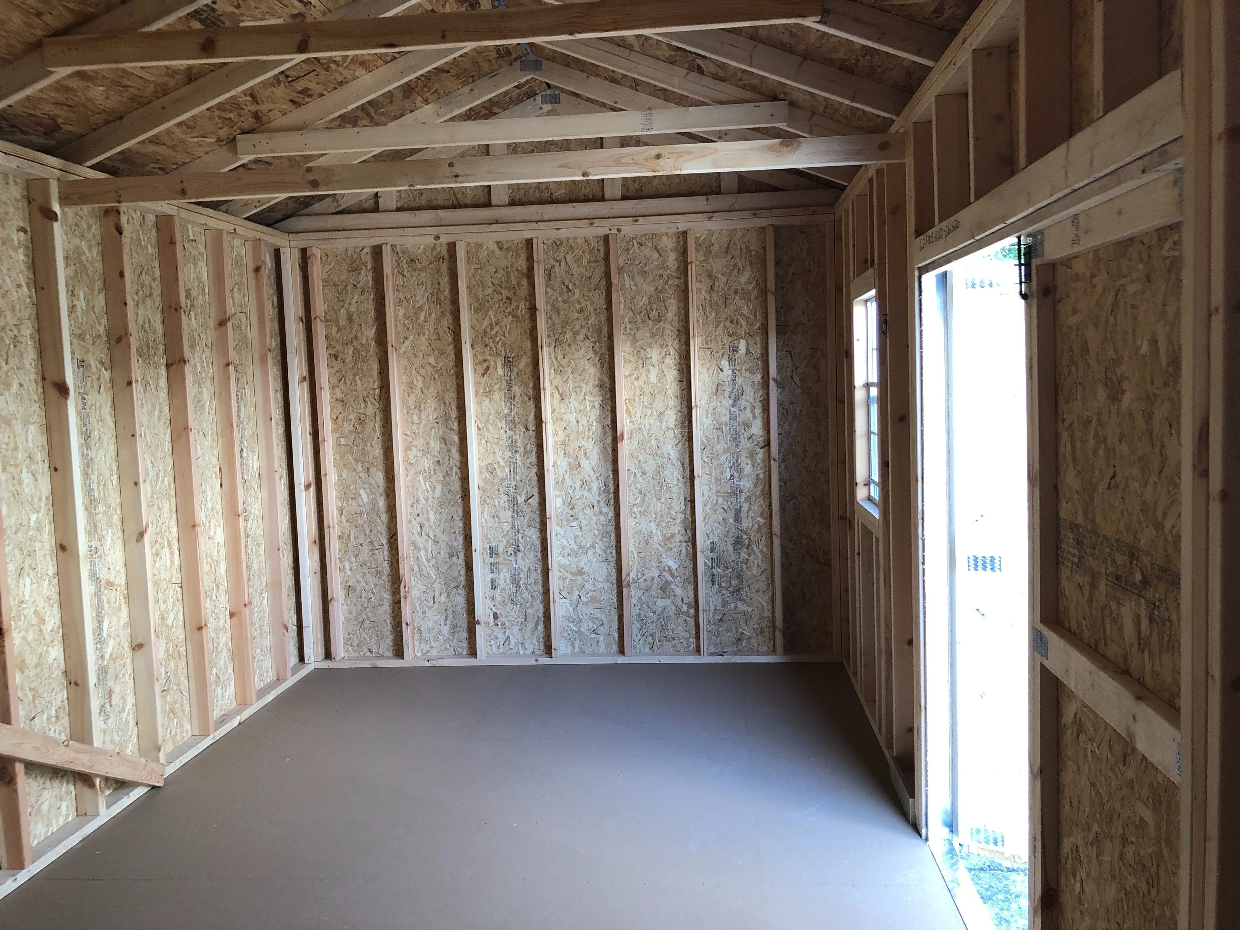 interior of 10x20 garden shed showing floor, window and door