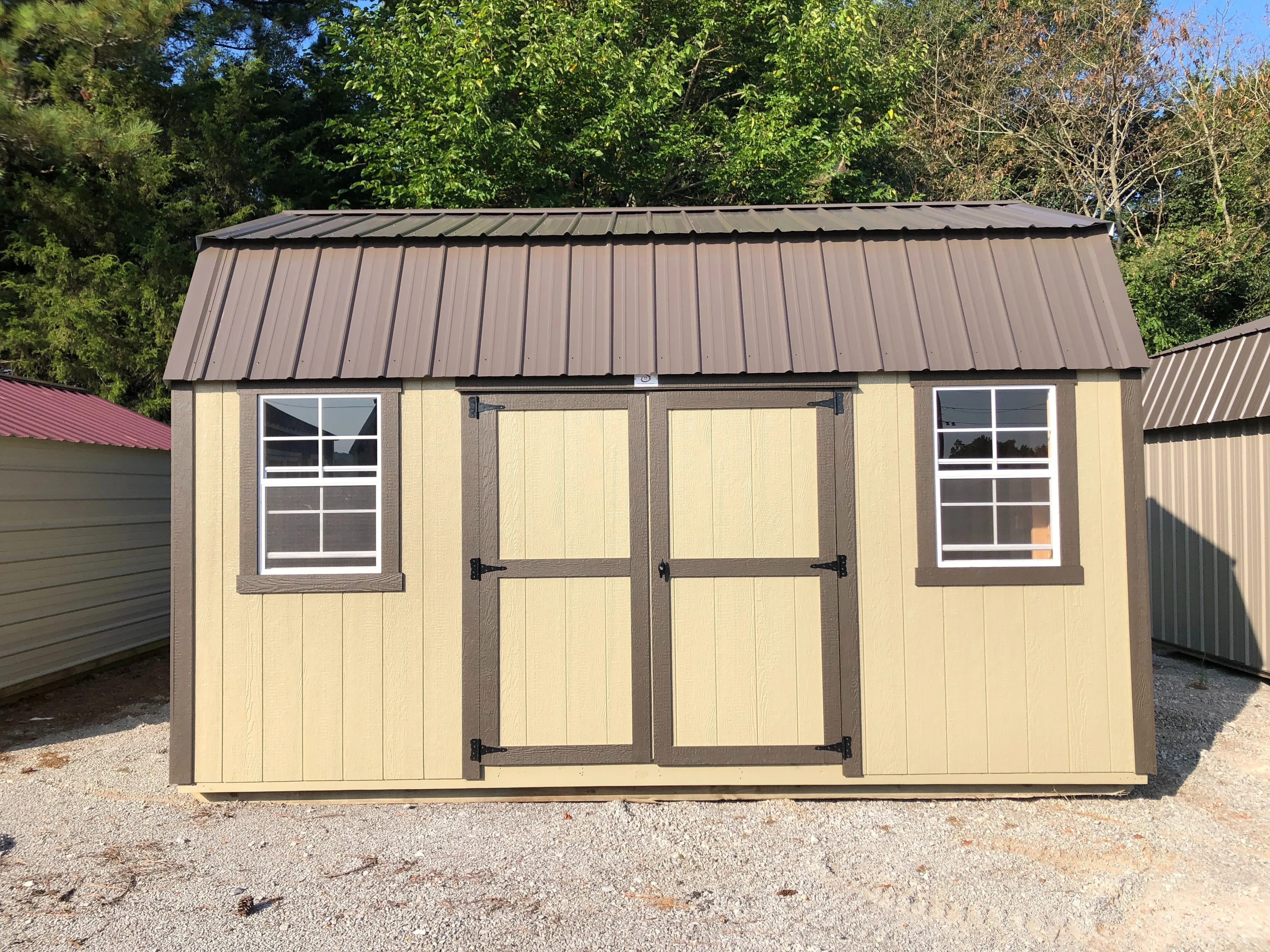 exterior of 12x16 side lofted barn showing double doors and windows