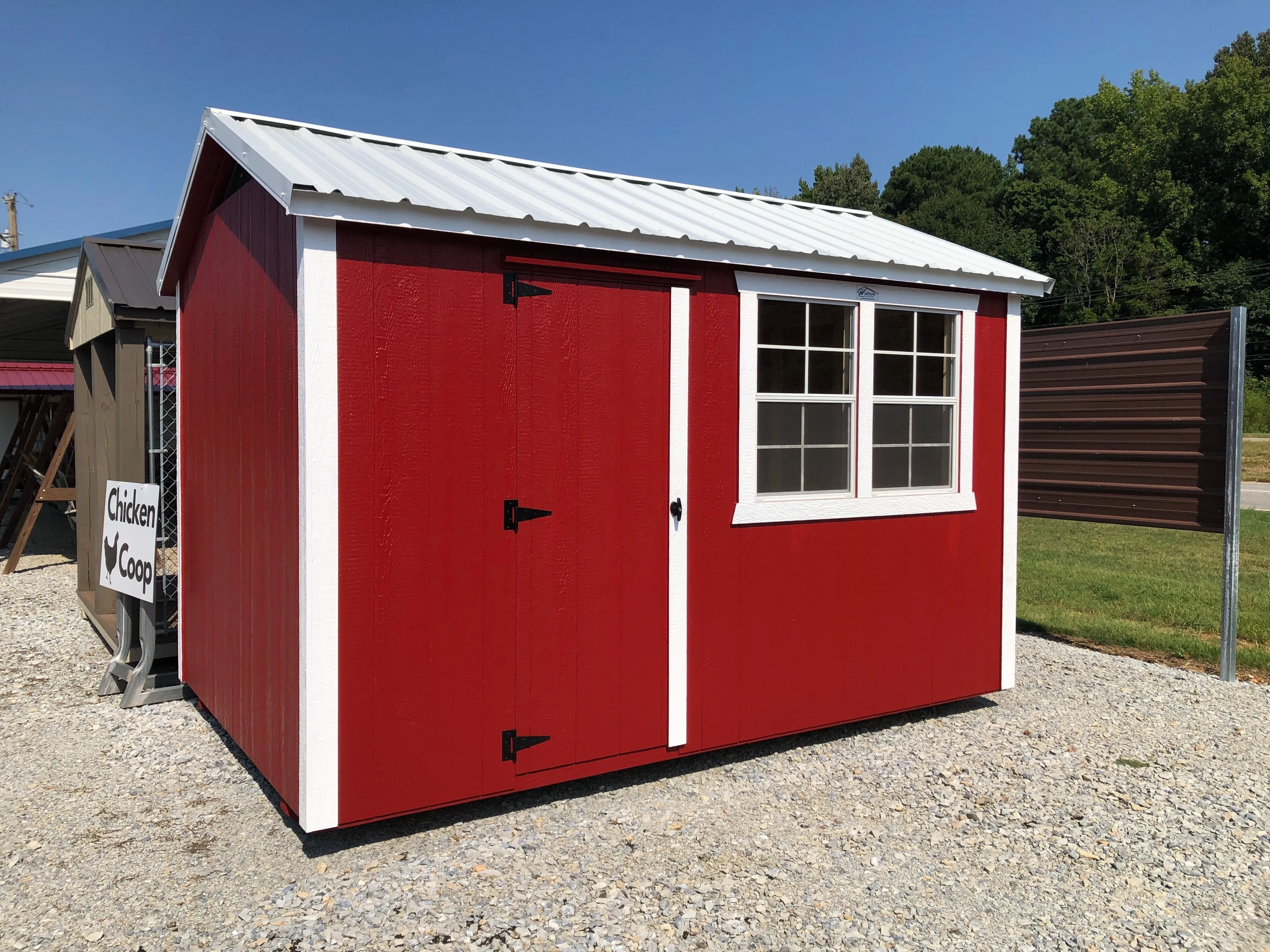 exterior of 8x12 chicken coop show a single entry door with 2 windows