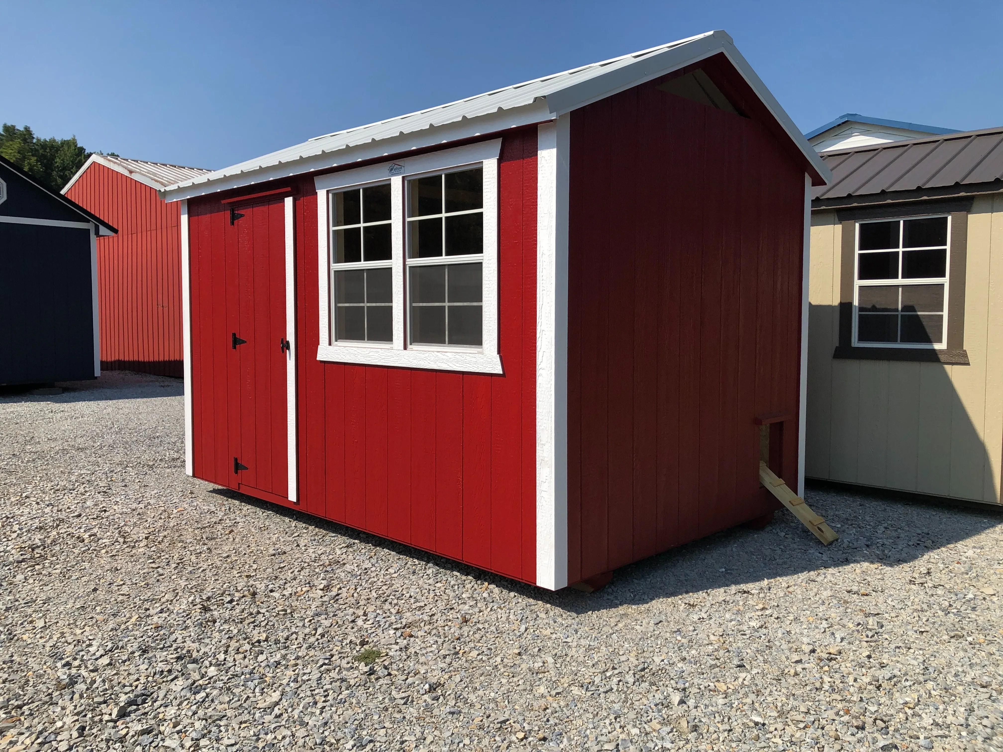 exterior of 8x12 chicken coop show a single entry door with 2 windows