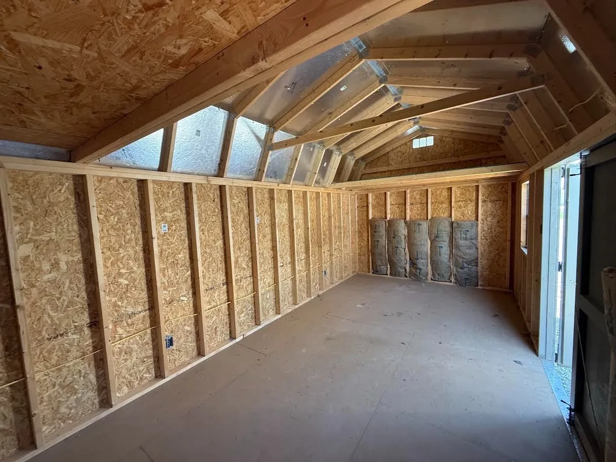 Inside of a 10x20 side garden shed with lofts in both ends and some batt insulation and wiring