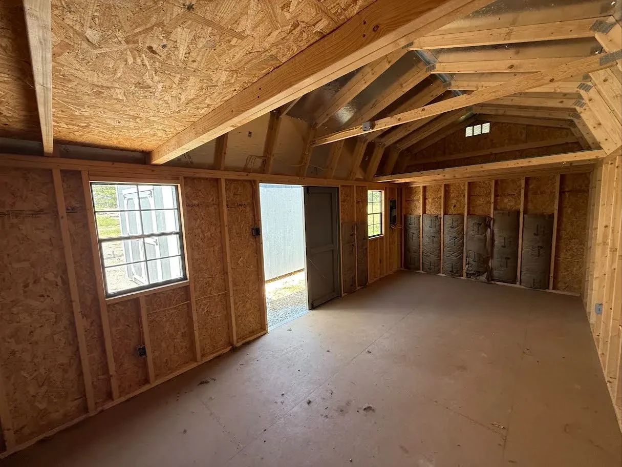 Inside of a 10x20 side garden shed with lofts in both ends and some batt insulation and wiring