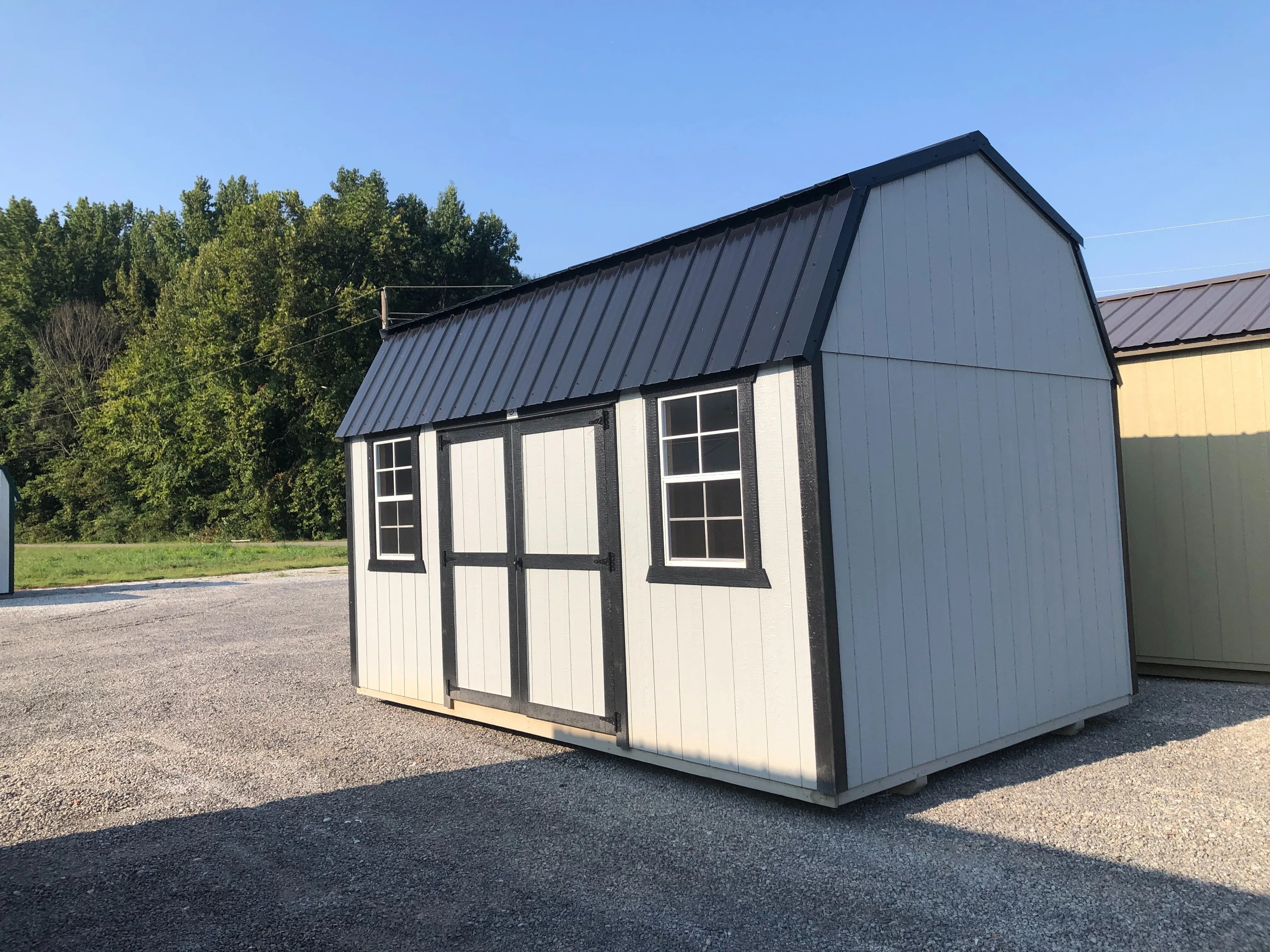 exterior of 10x16 side lofted barn showing doors and windows