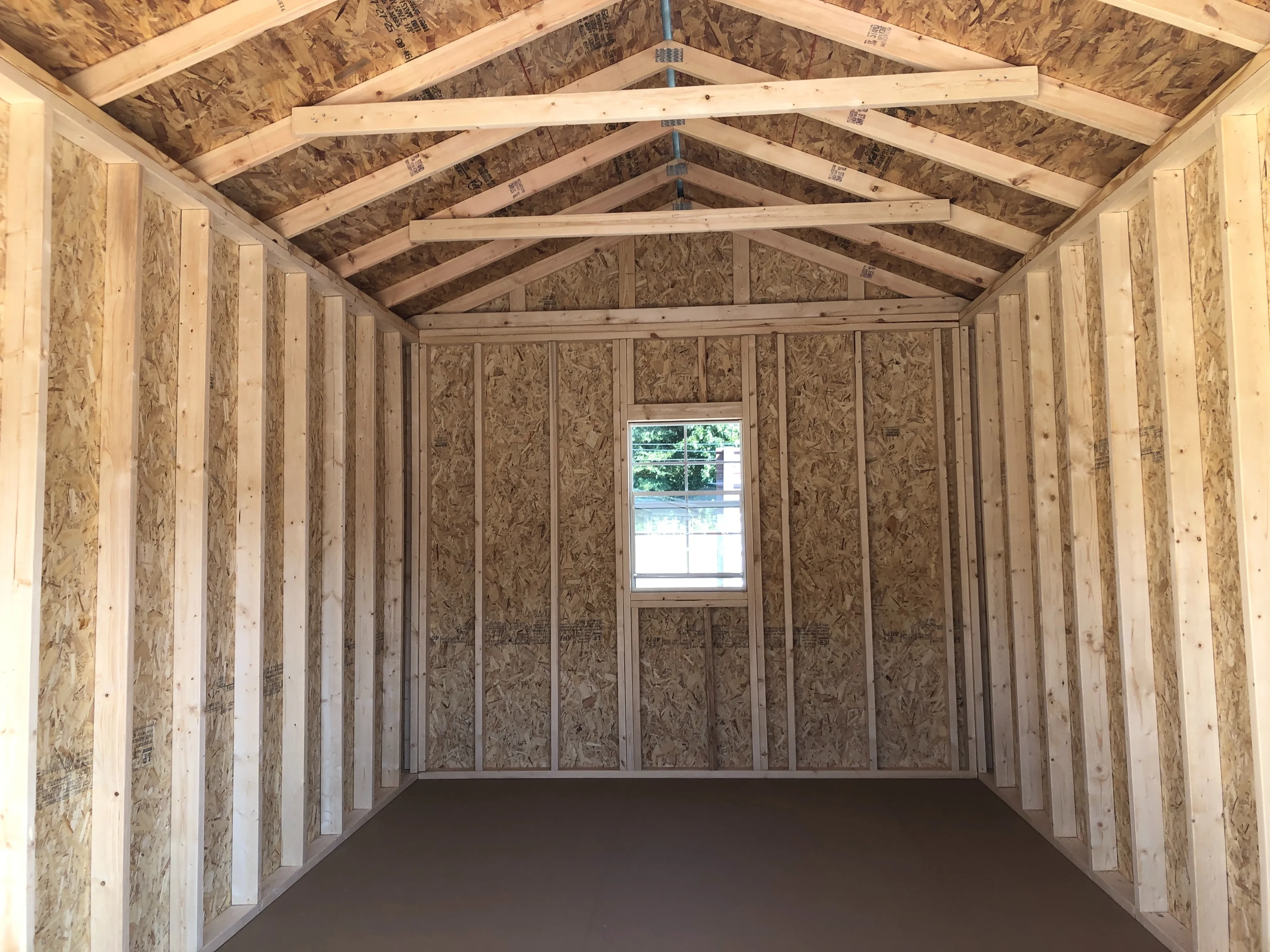 interior of 10x16 utility shed showing the floor, walls and a window