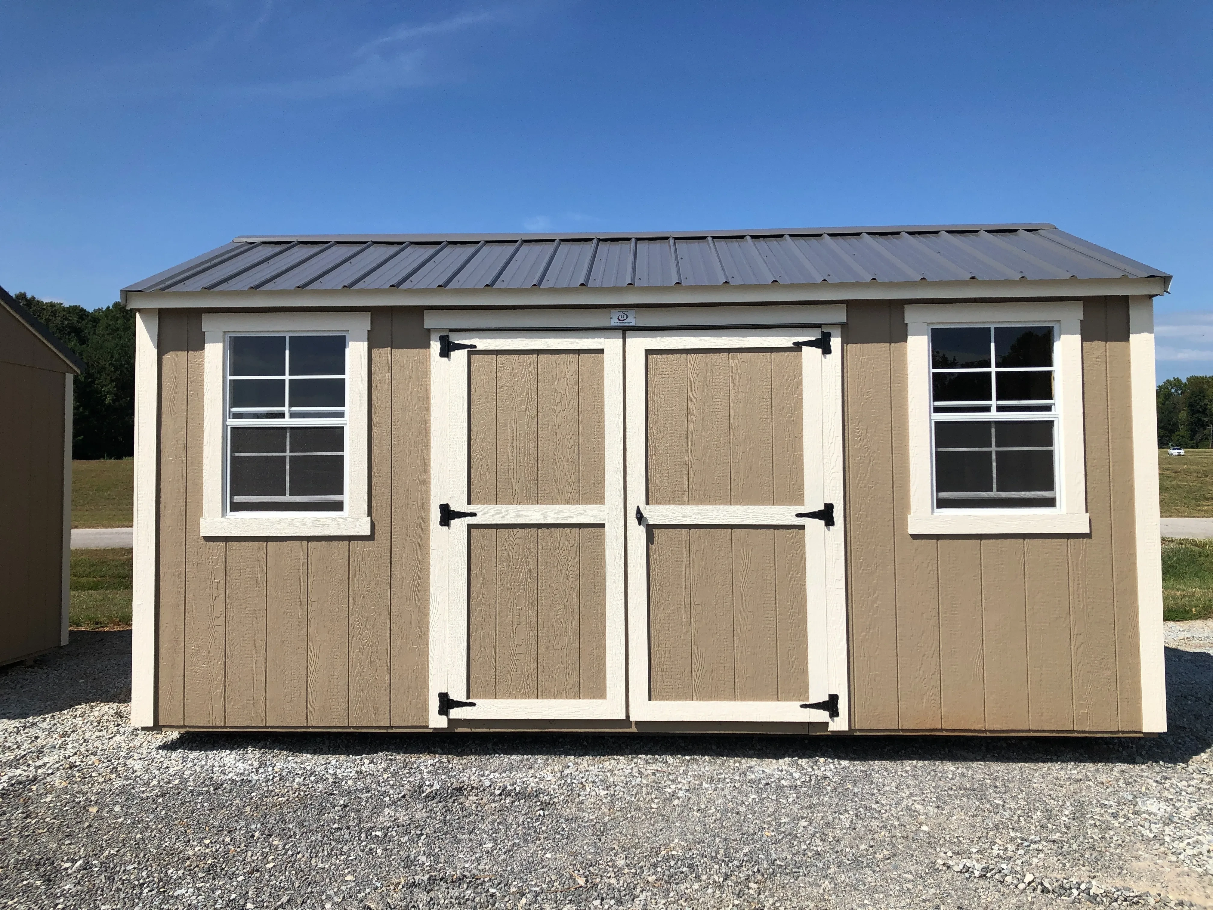 exterior of 8x16 garden shed showing double doors and 2 windows