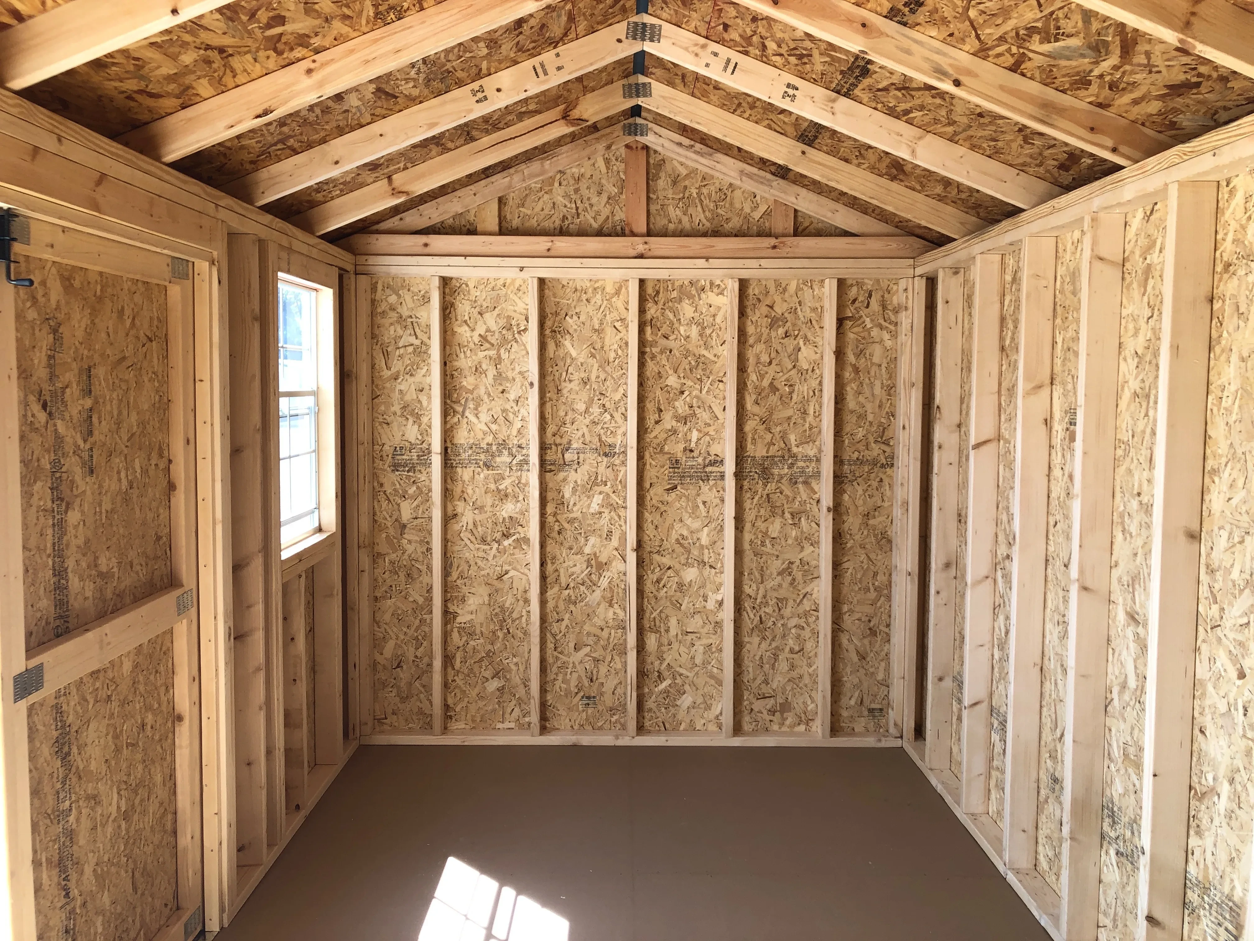 interior of 8x16 garden shed showing floor, walls, window and doorway