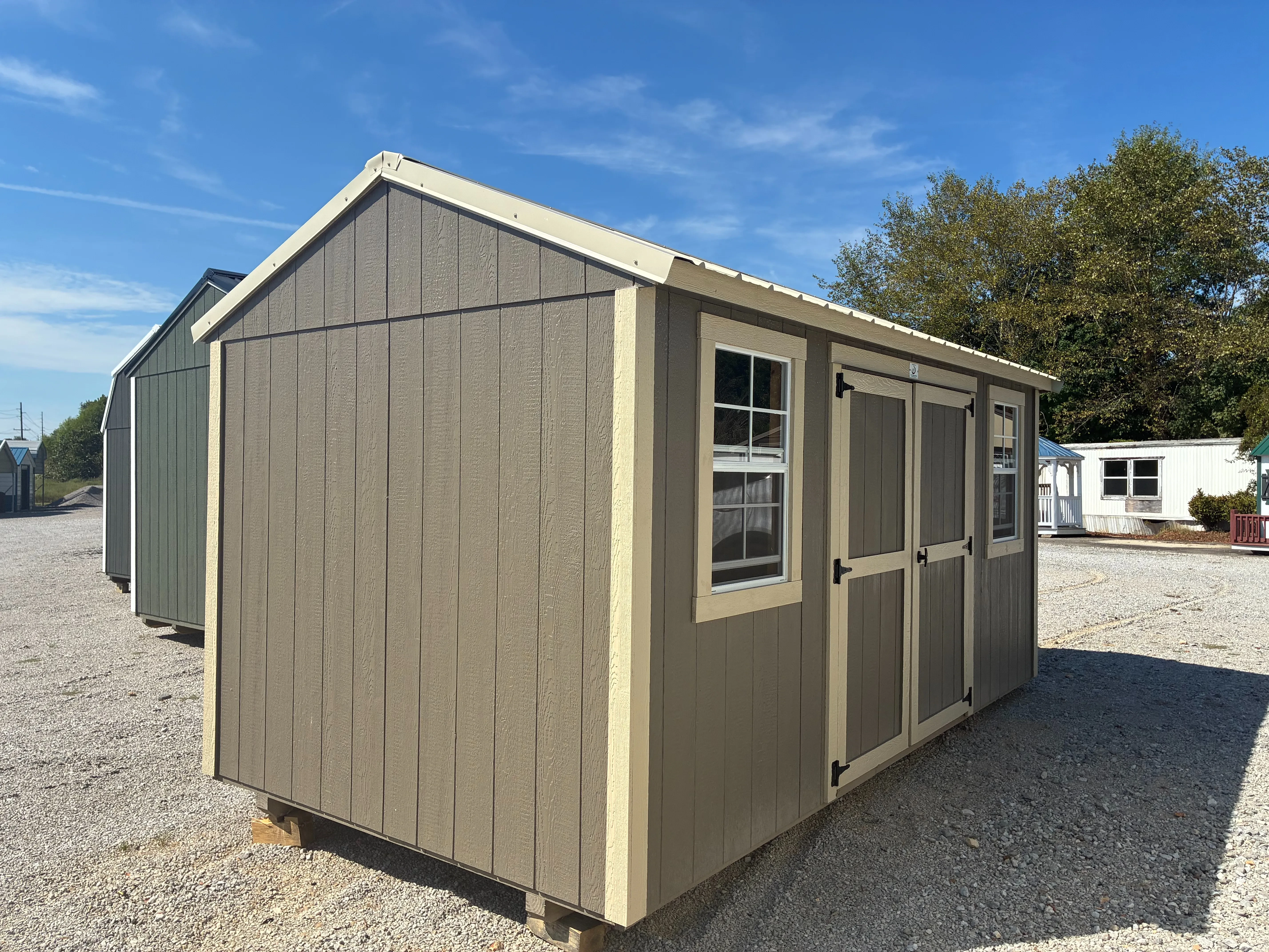Exterior of 8x12 Garden Shed showing double doors and 2 windows with beige trim