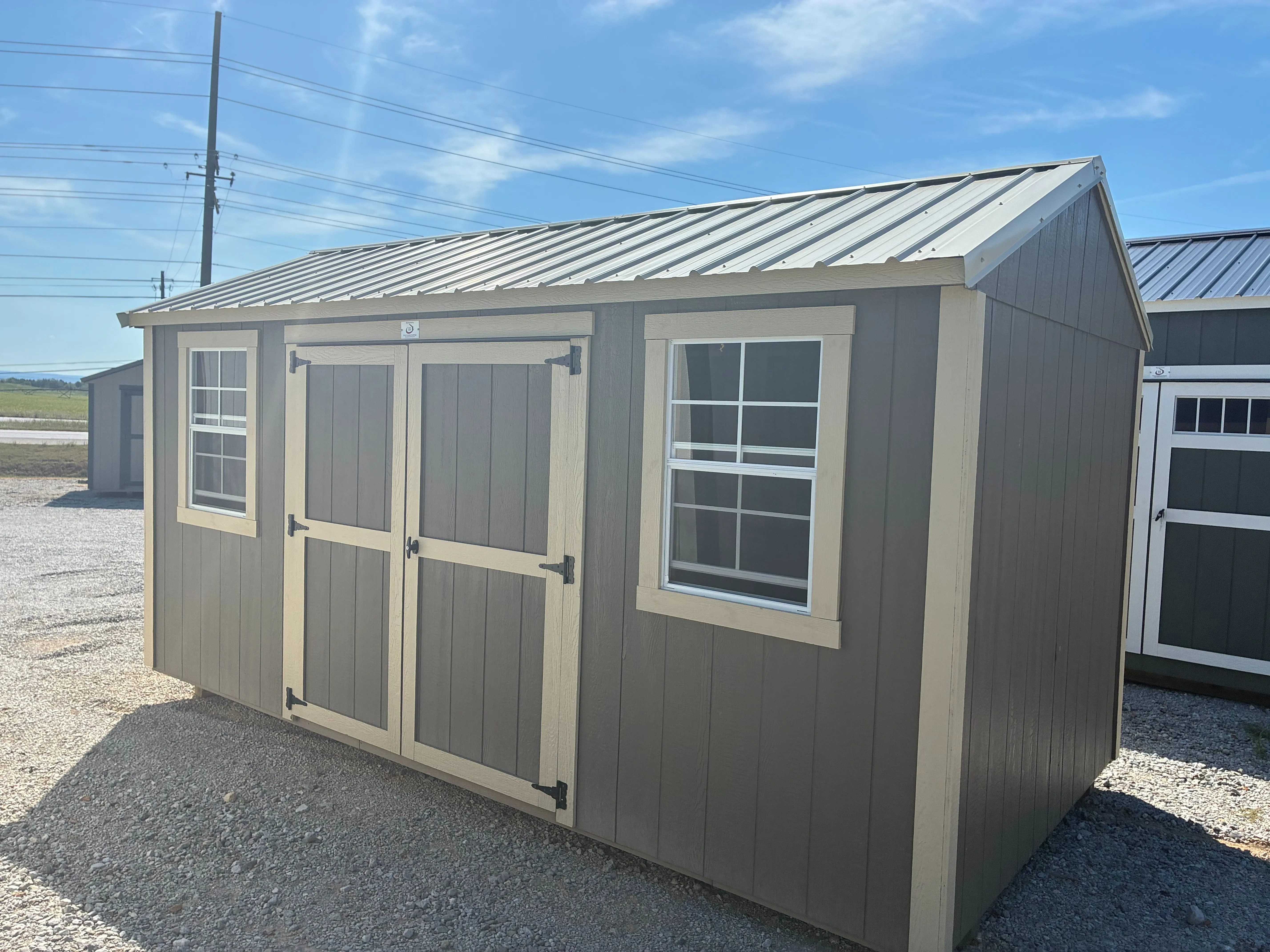 Exterior of 8x12 Garden Shed showing double doors and 2 windows with beige trim