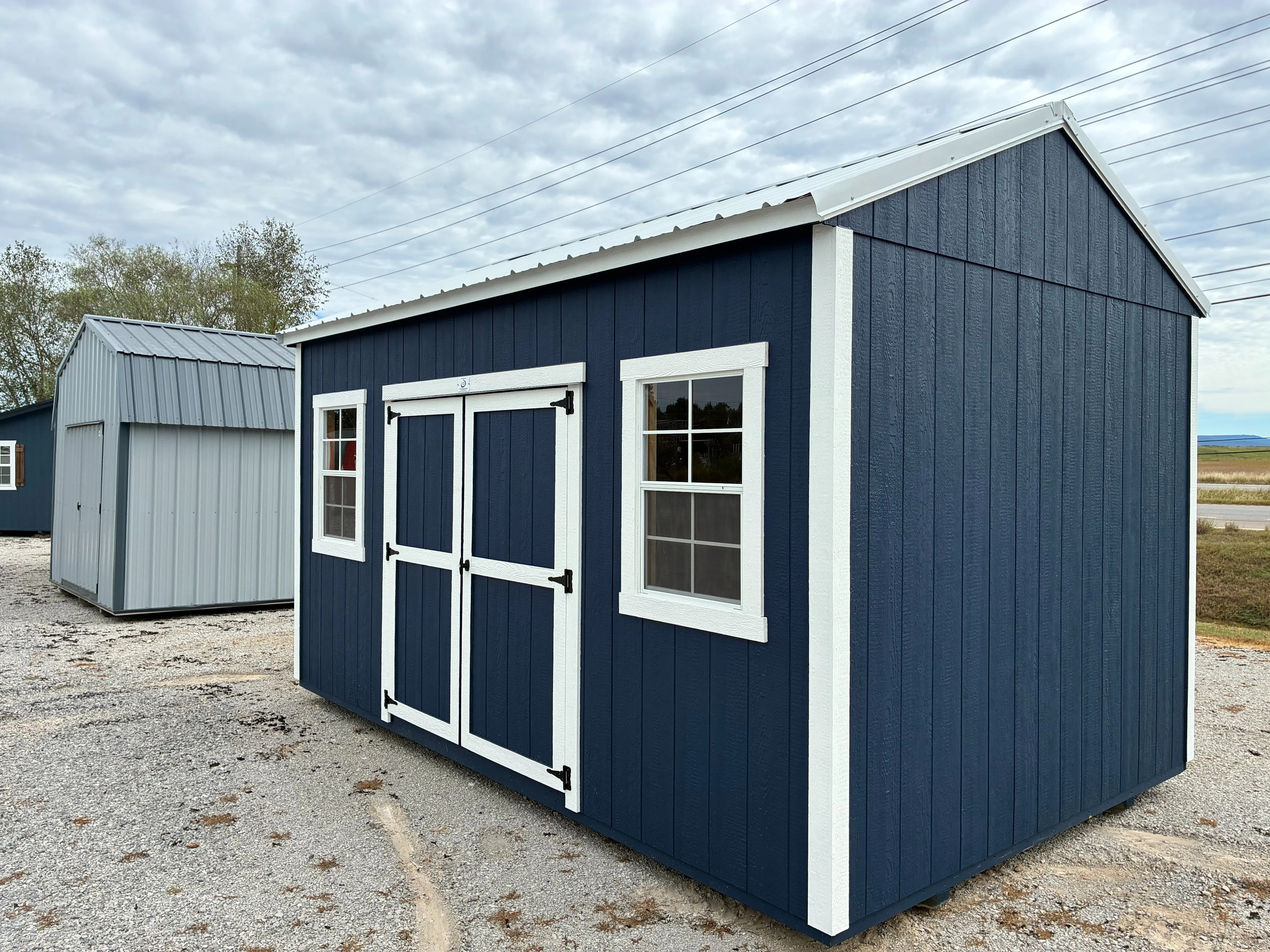 exterior of 10x16 Deep ocean garden shed showing double doors with white trim and 2 windows