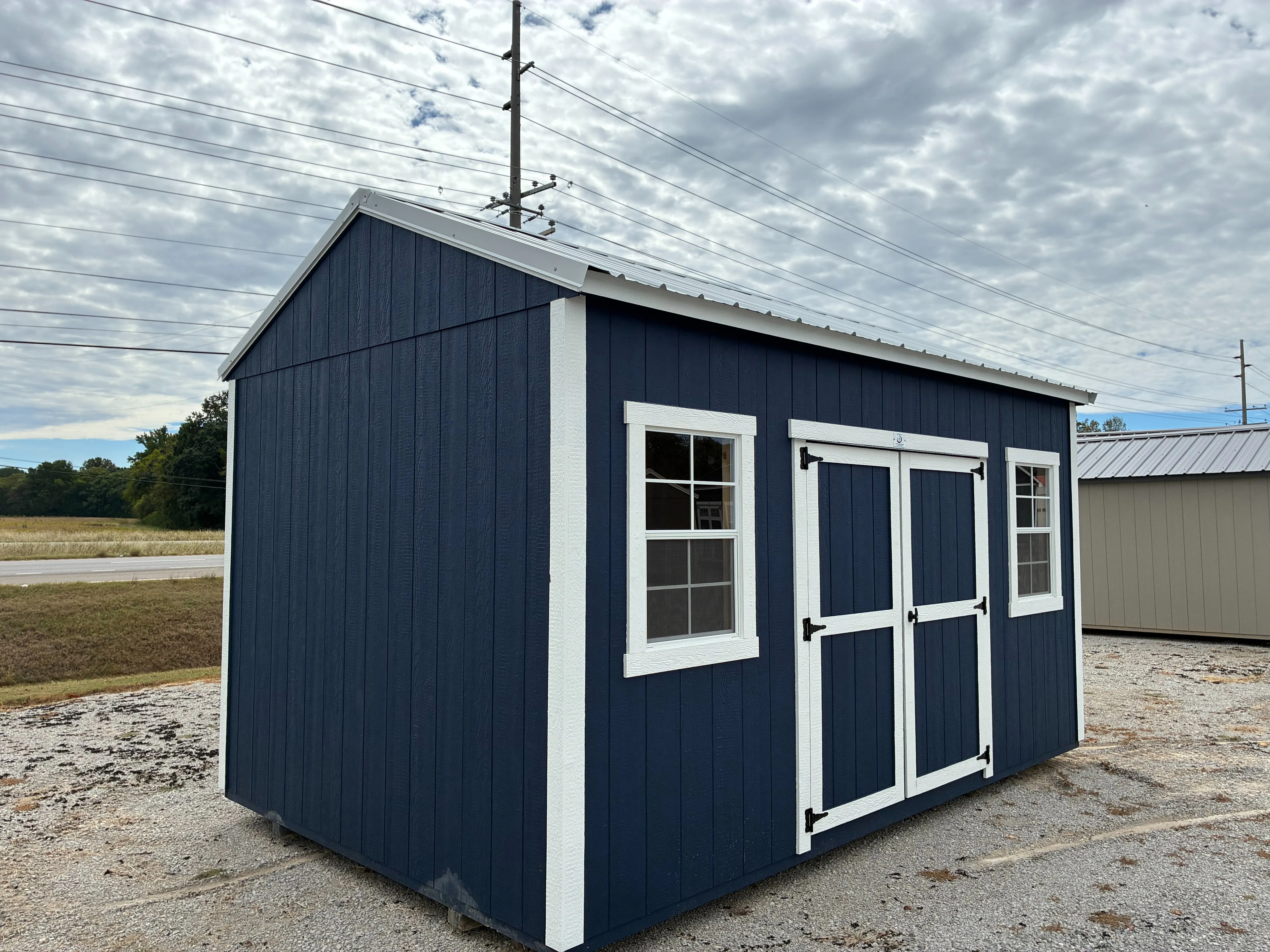 exterior of 10x16 Deep ocean garden shed showing double doors with white trim and 2 windows