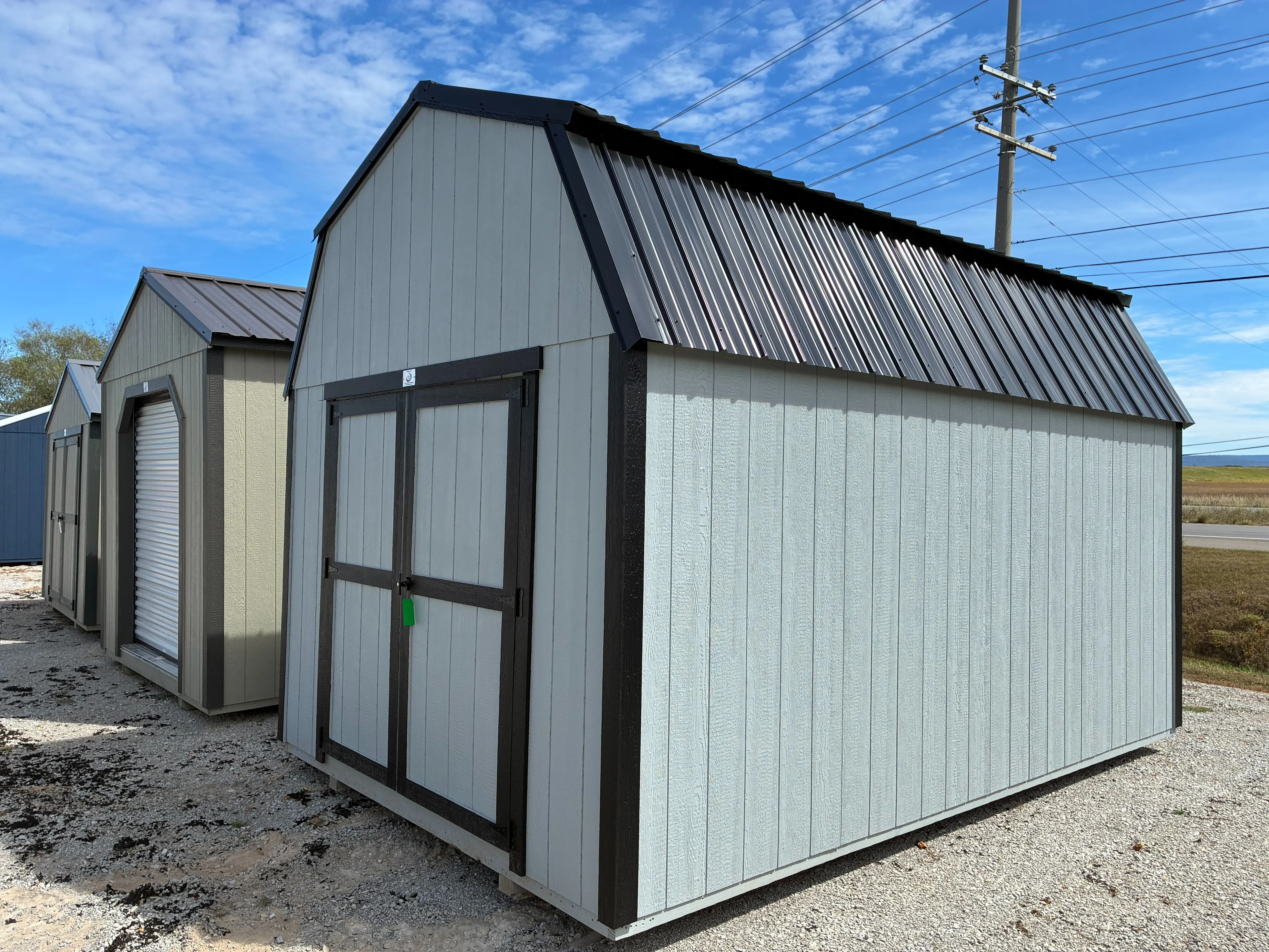 exterior of 10x16 Zook grey lofted barn showing wood double doors with black trim