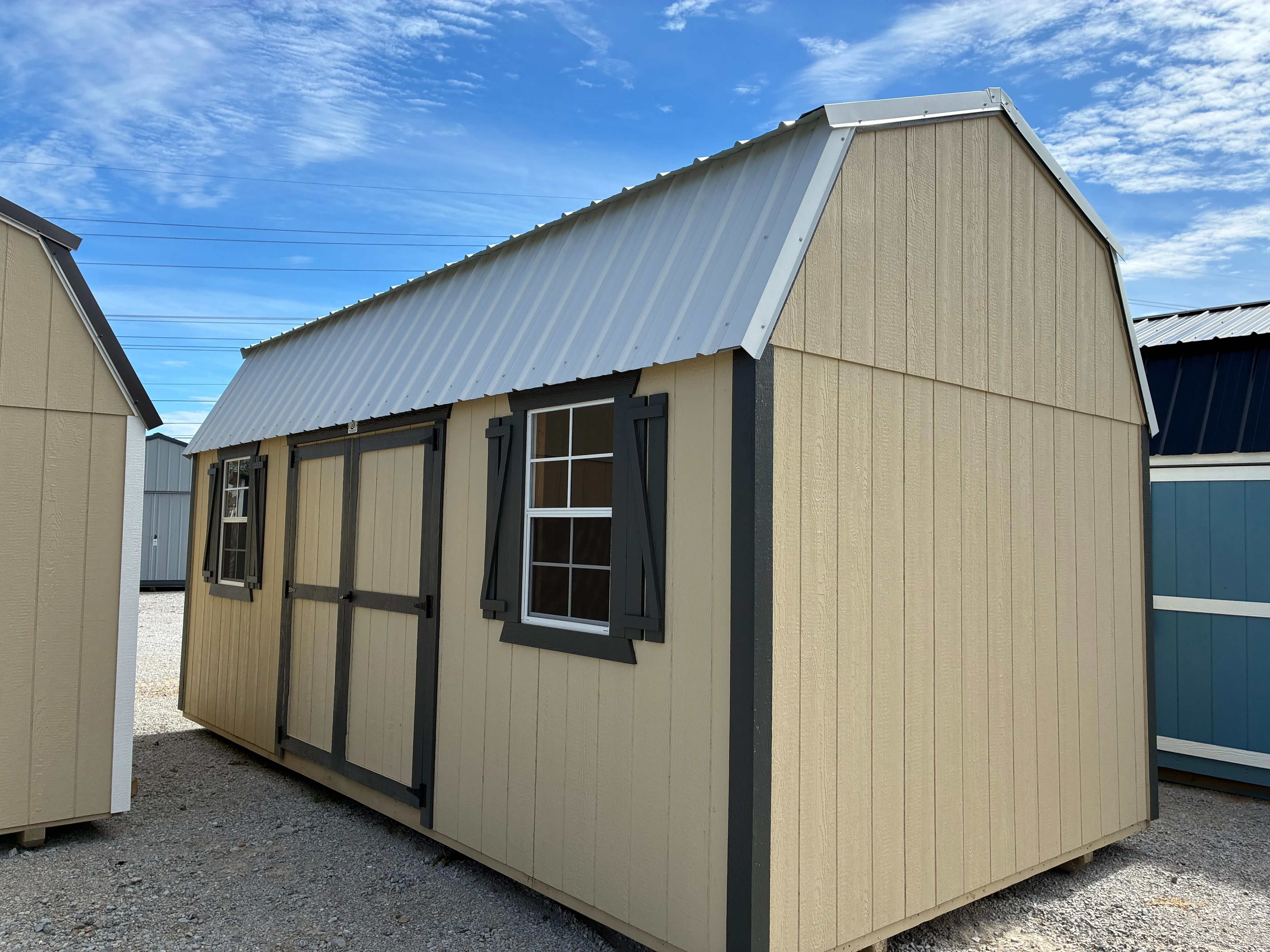 exterior of 10x20 side lofted barn in new holland beige with double doors and windows with shutters burnished slate trim