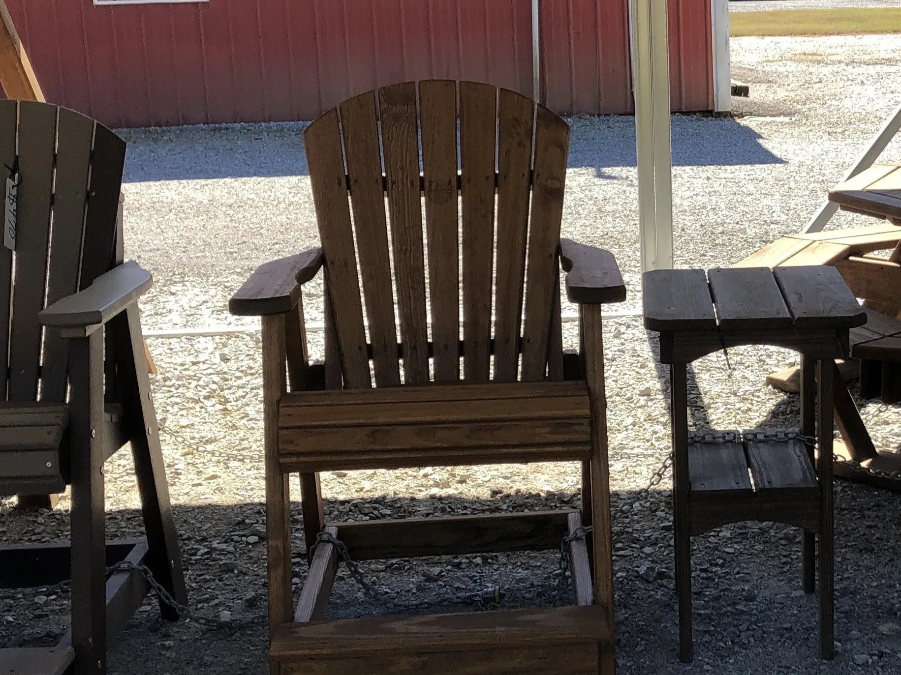 a wood stained and sealed chair with arm and foot rests
