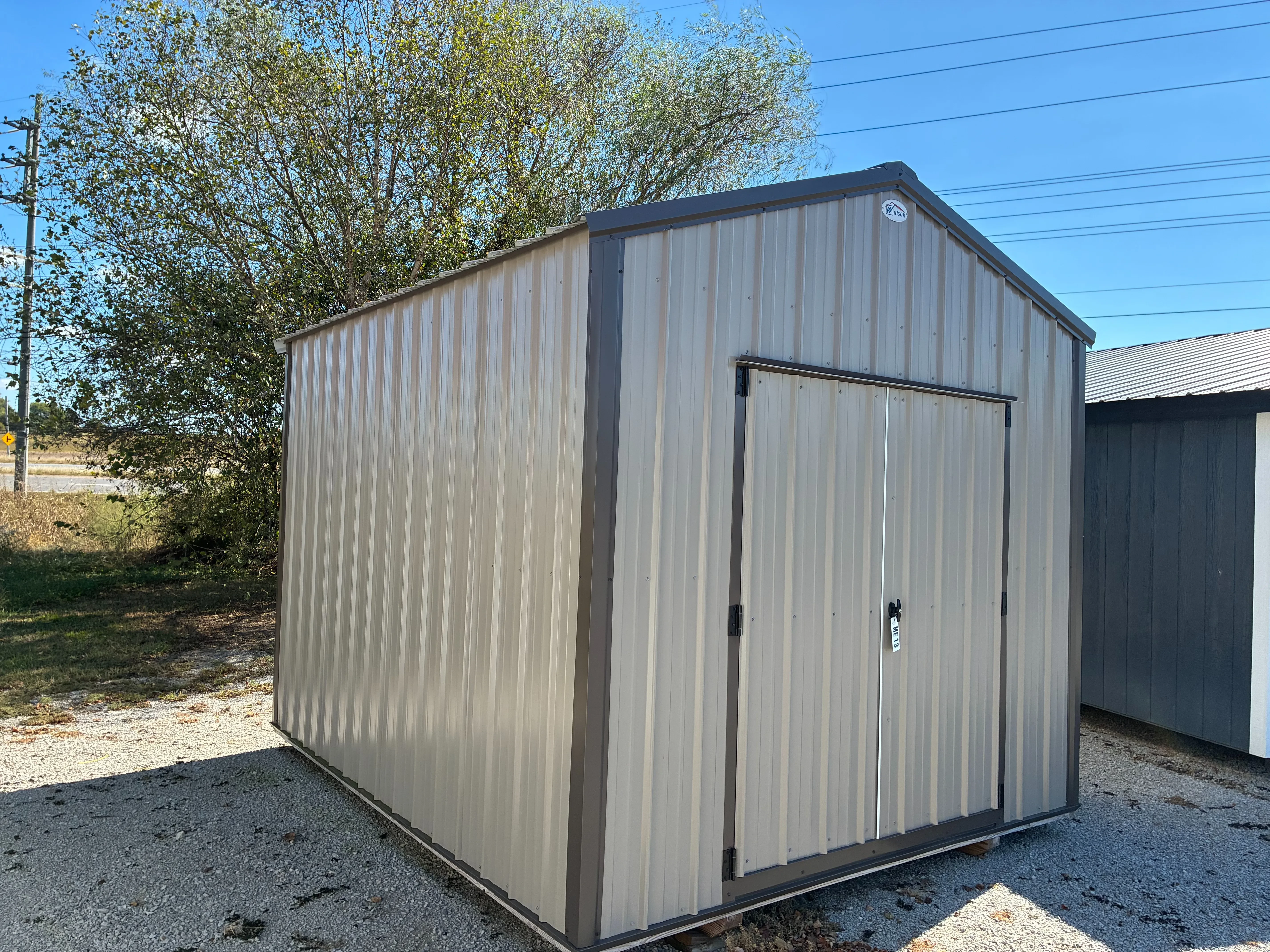 Exterior of 10x12 Metal Utility Shed showing double doors