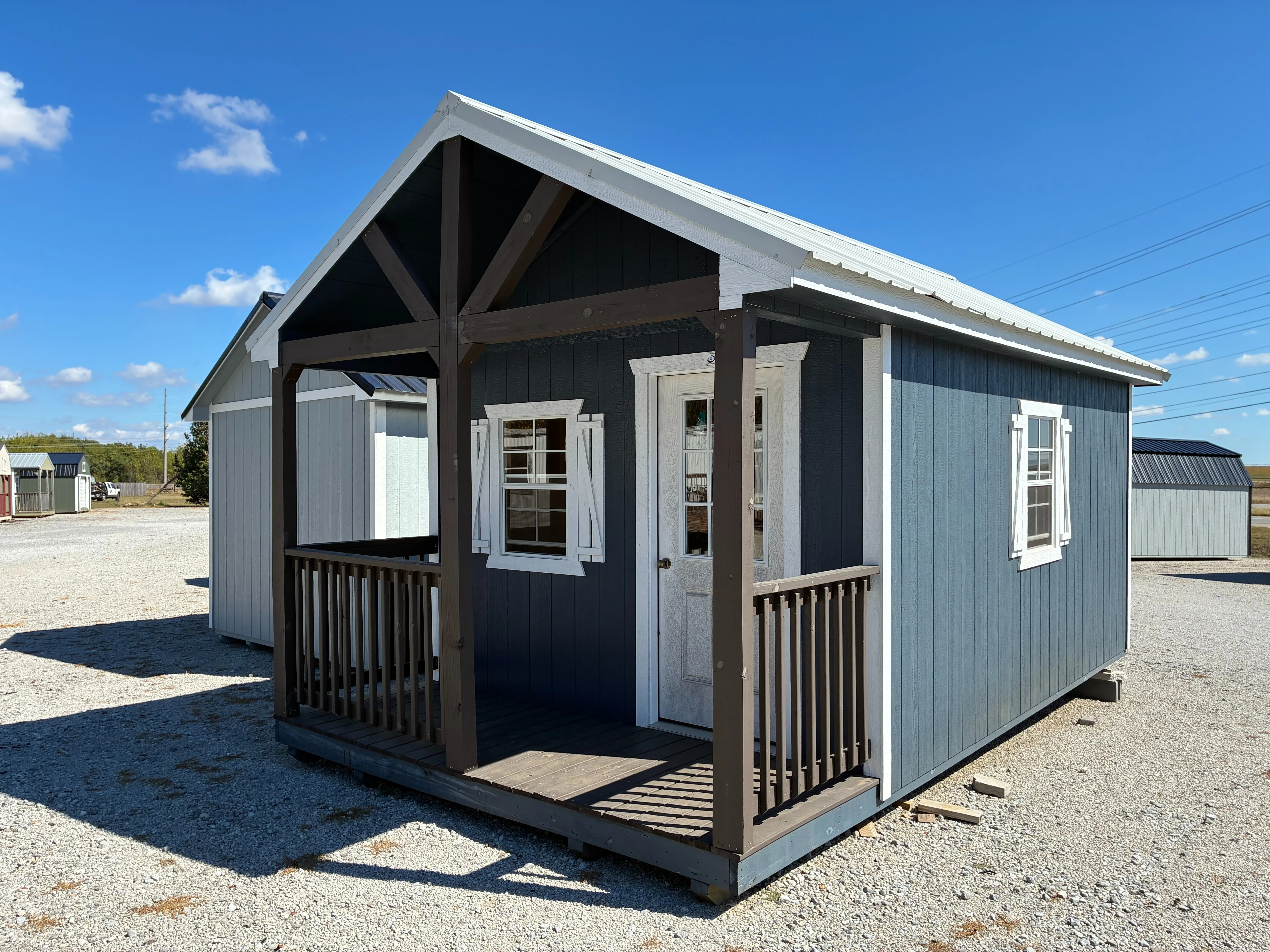 12x20 Wood Cabin with vaulted porch, it also has 2x3 window with shutters and a walk in door
