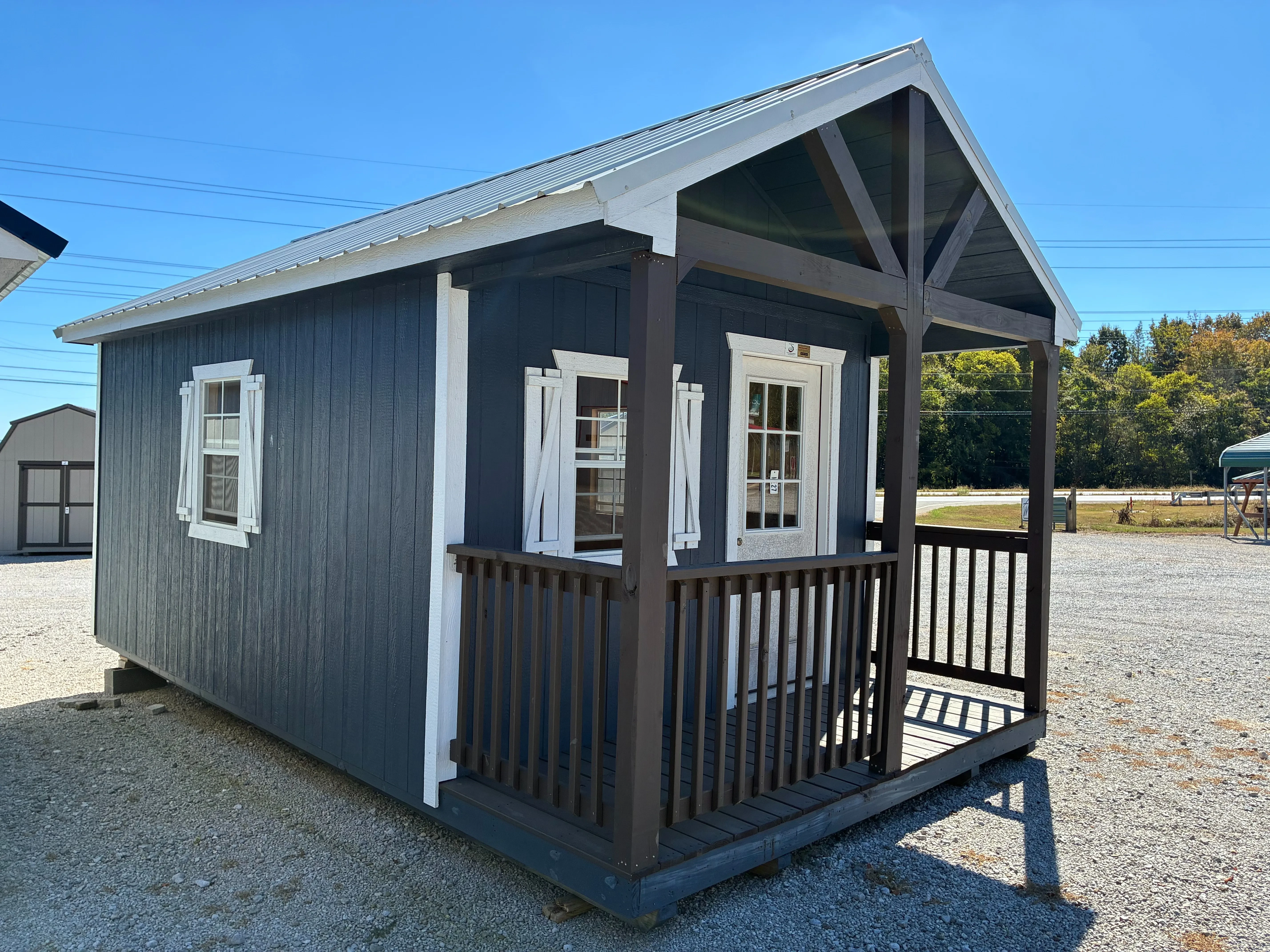 12x20 Wood Cabin with vaulted porch, it also has 2x3 window with shutters and a walk in door
