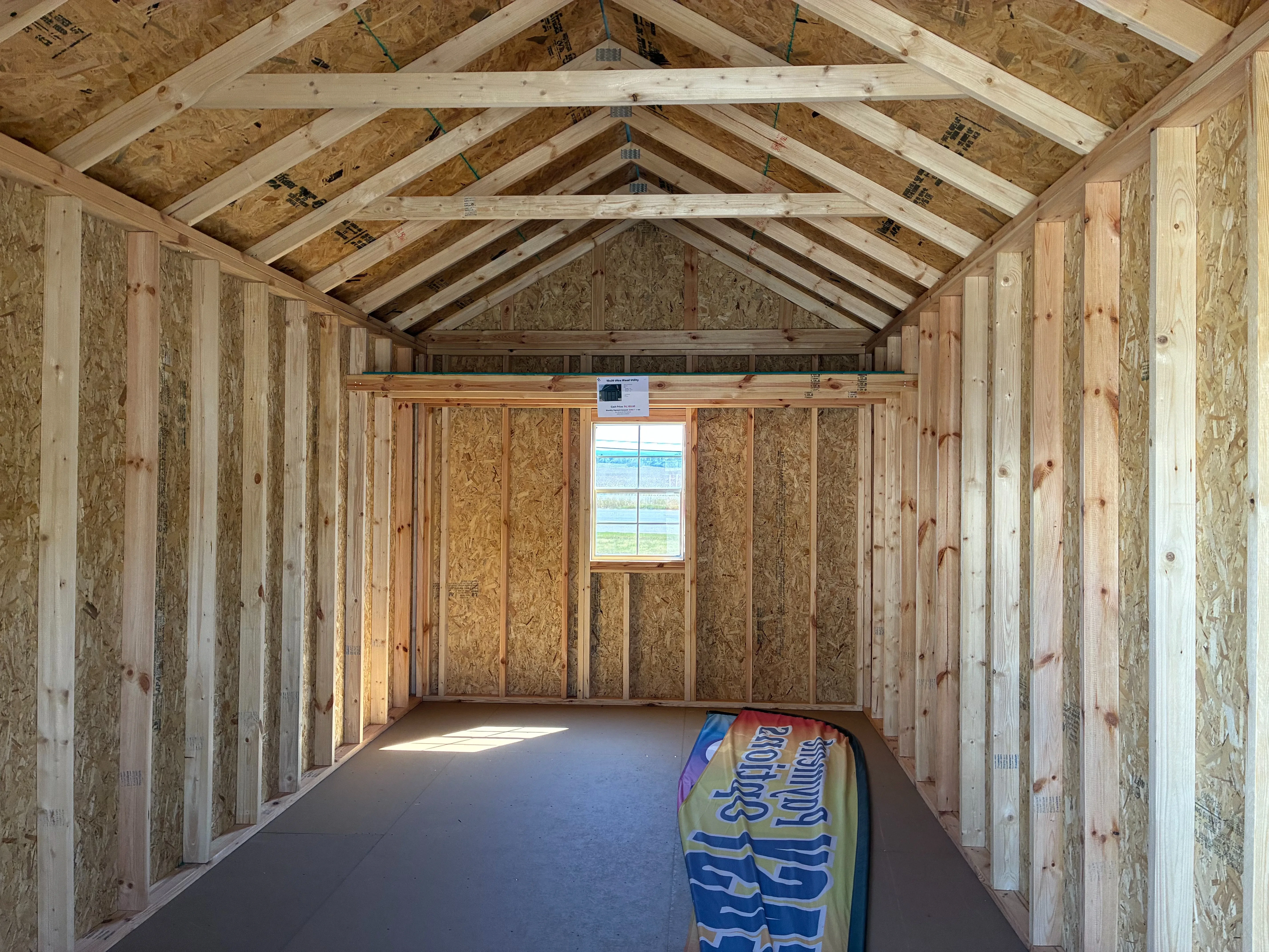 Interior of 10x20 Ultra Shed showing 4' loft and 2'x3' window on back wall