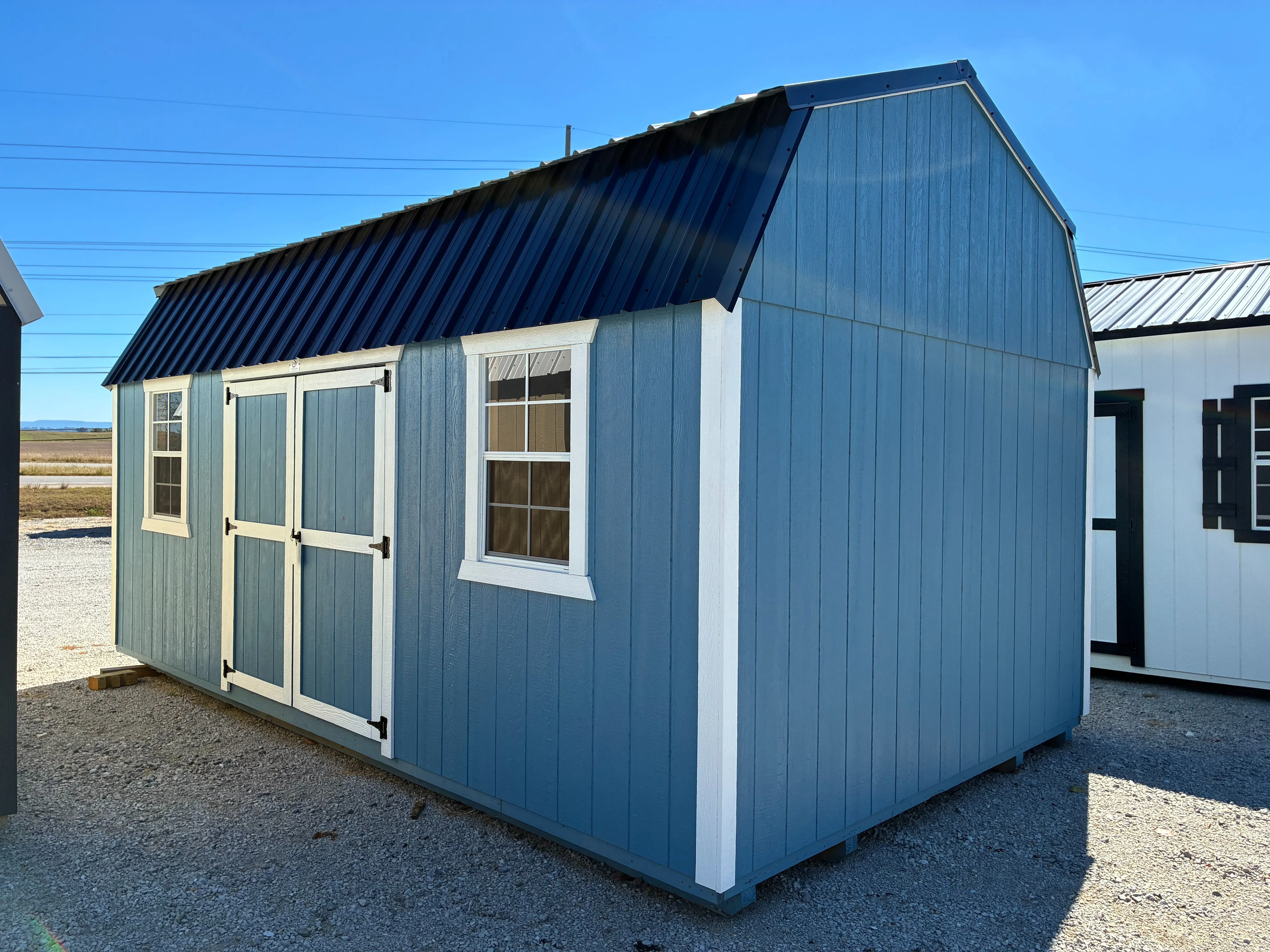 Exterior of 12x20 Classic Wood Side Lofted Barn showing double doors and 2x 2'x3' windows
