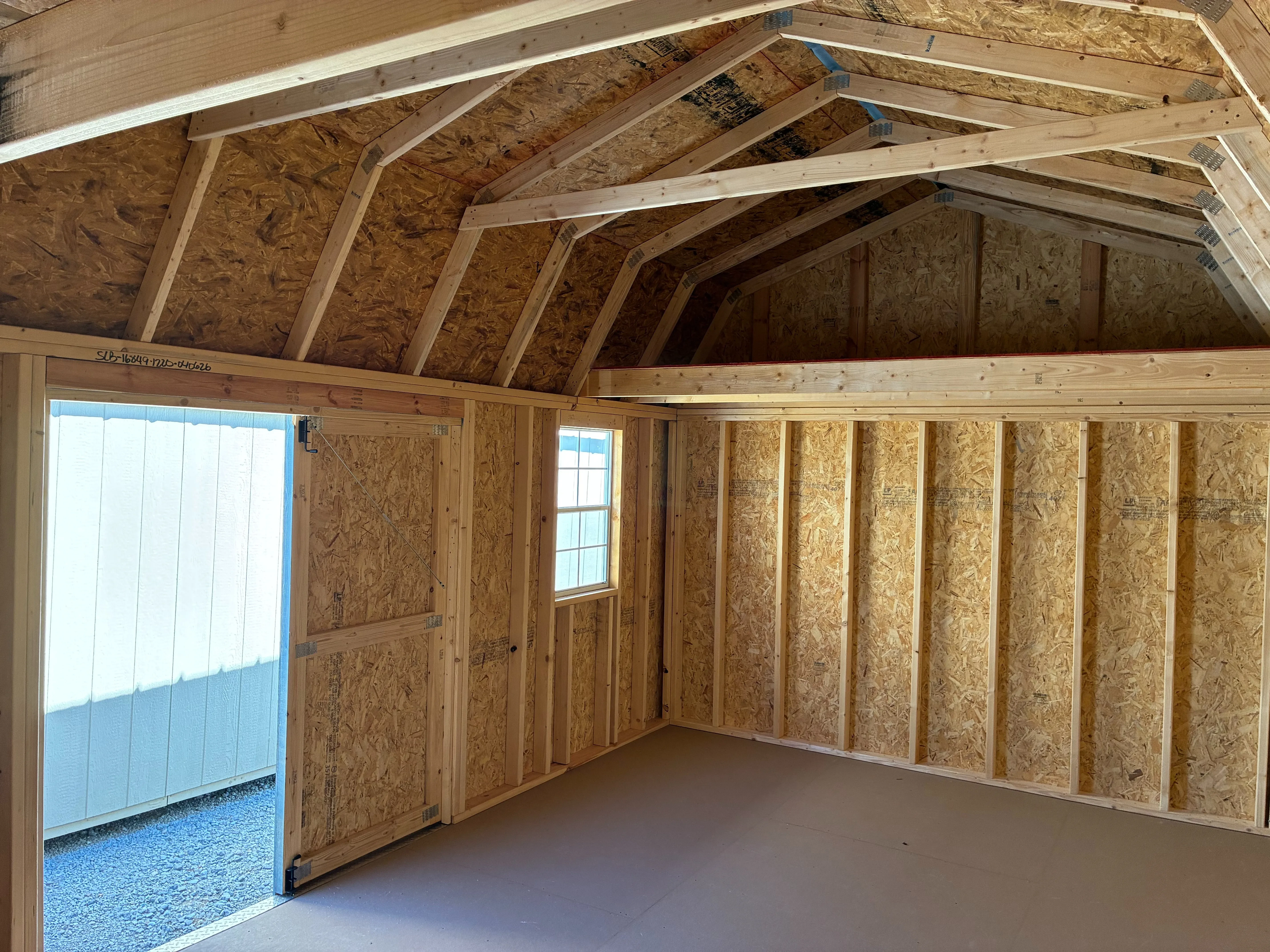 Interior of 12x24 Side Lofted Barn showing 4' loft and window
