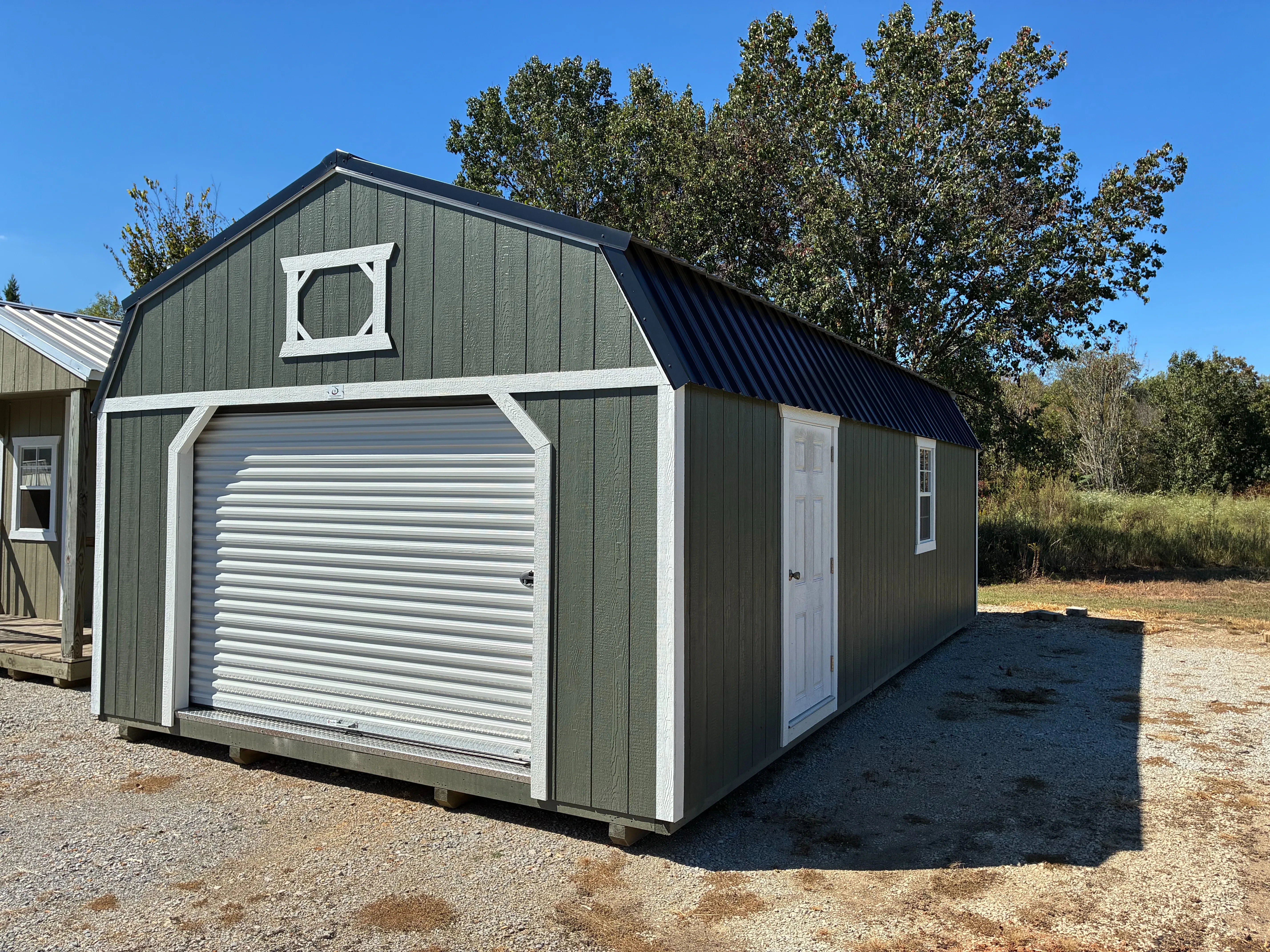 Exterior of 14x28 Classic Wood Lofted Garage showing 2'x3' window and 36" solid panel fiberglass door