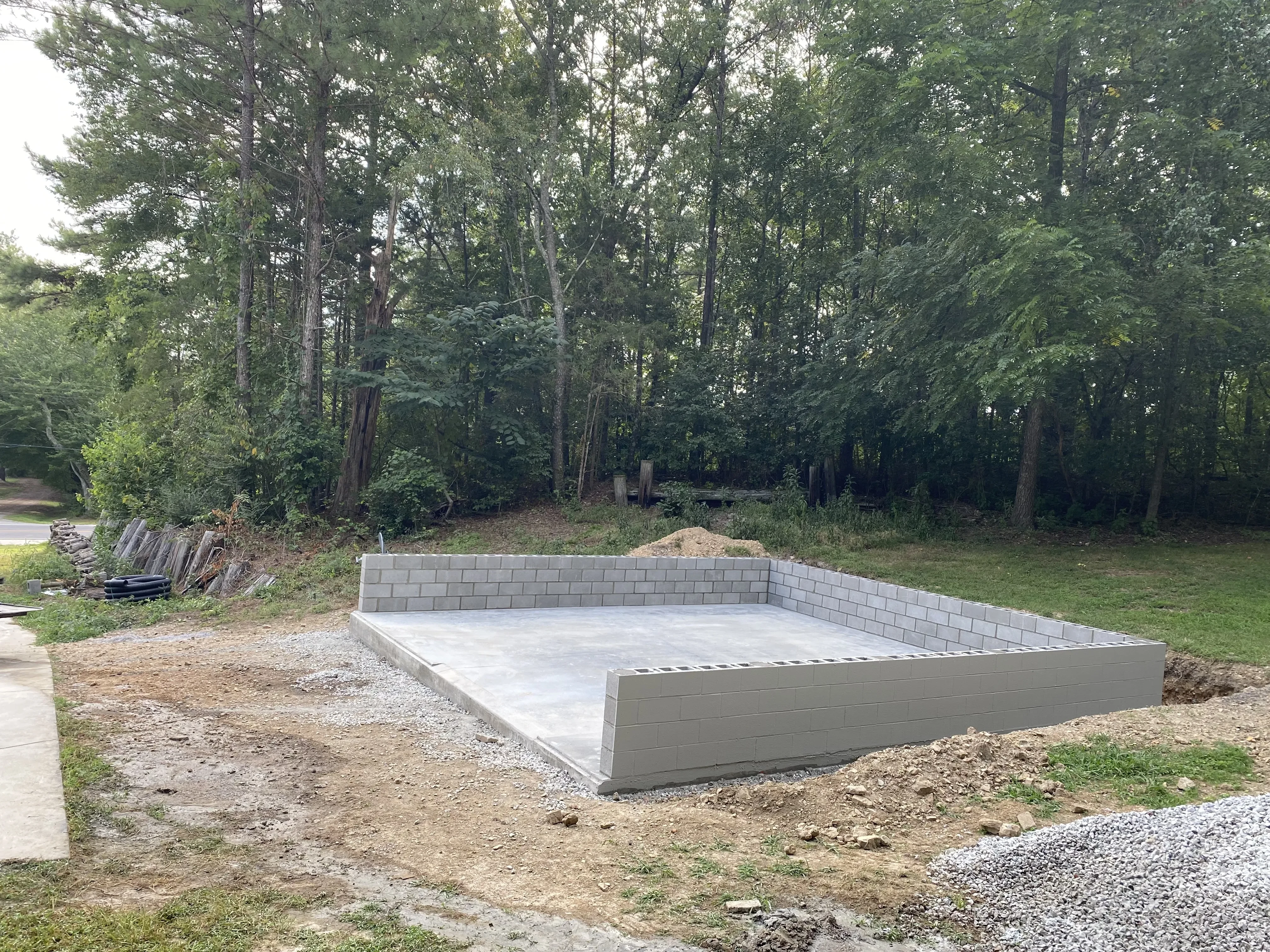 Garage site with retaining wall built.