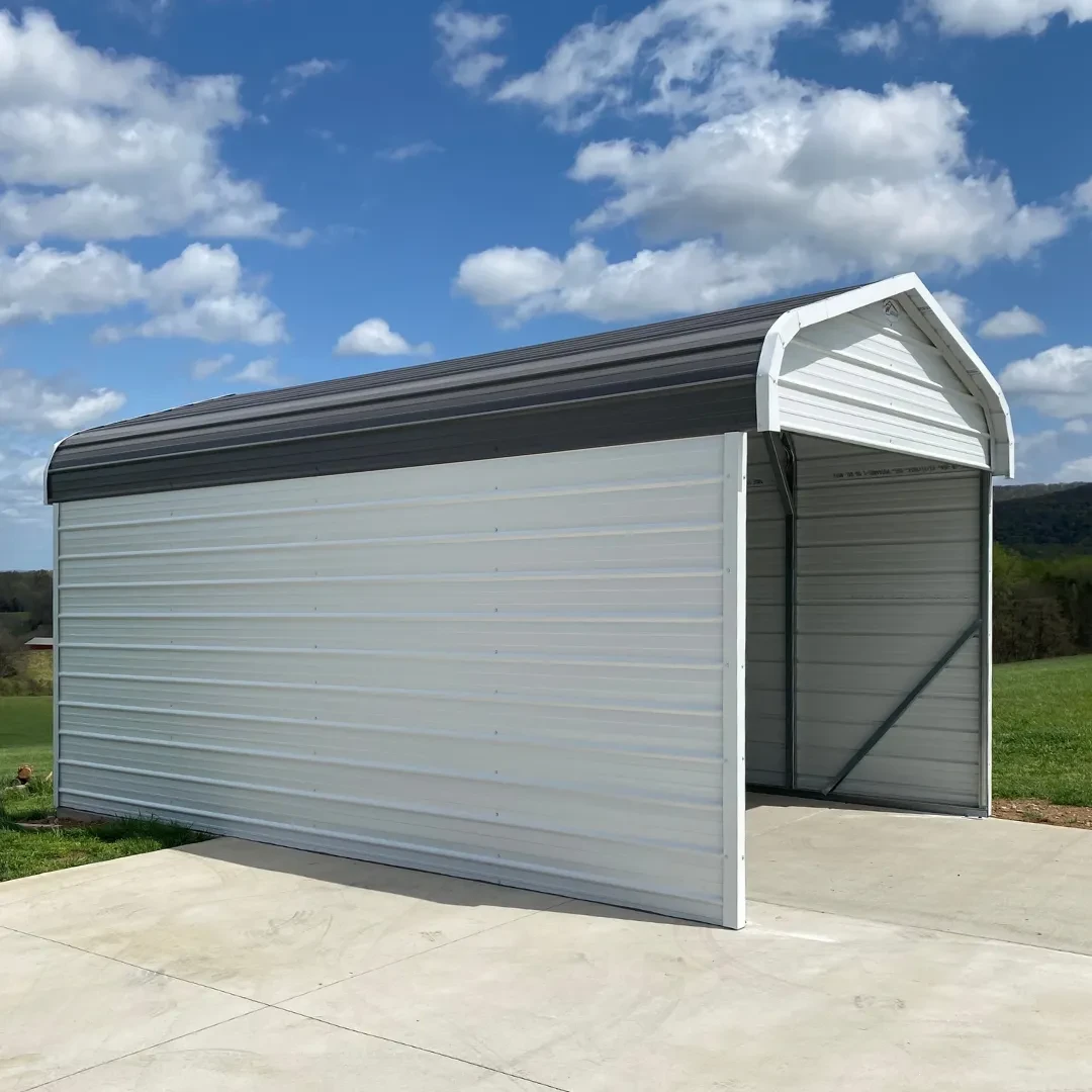 a round frame carport with white side walls and a closed gable with a charcoal roof