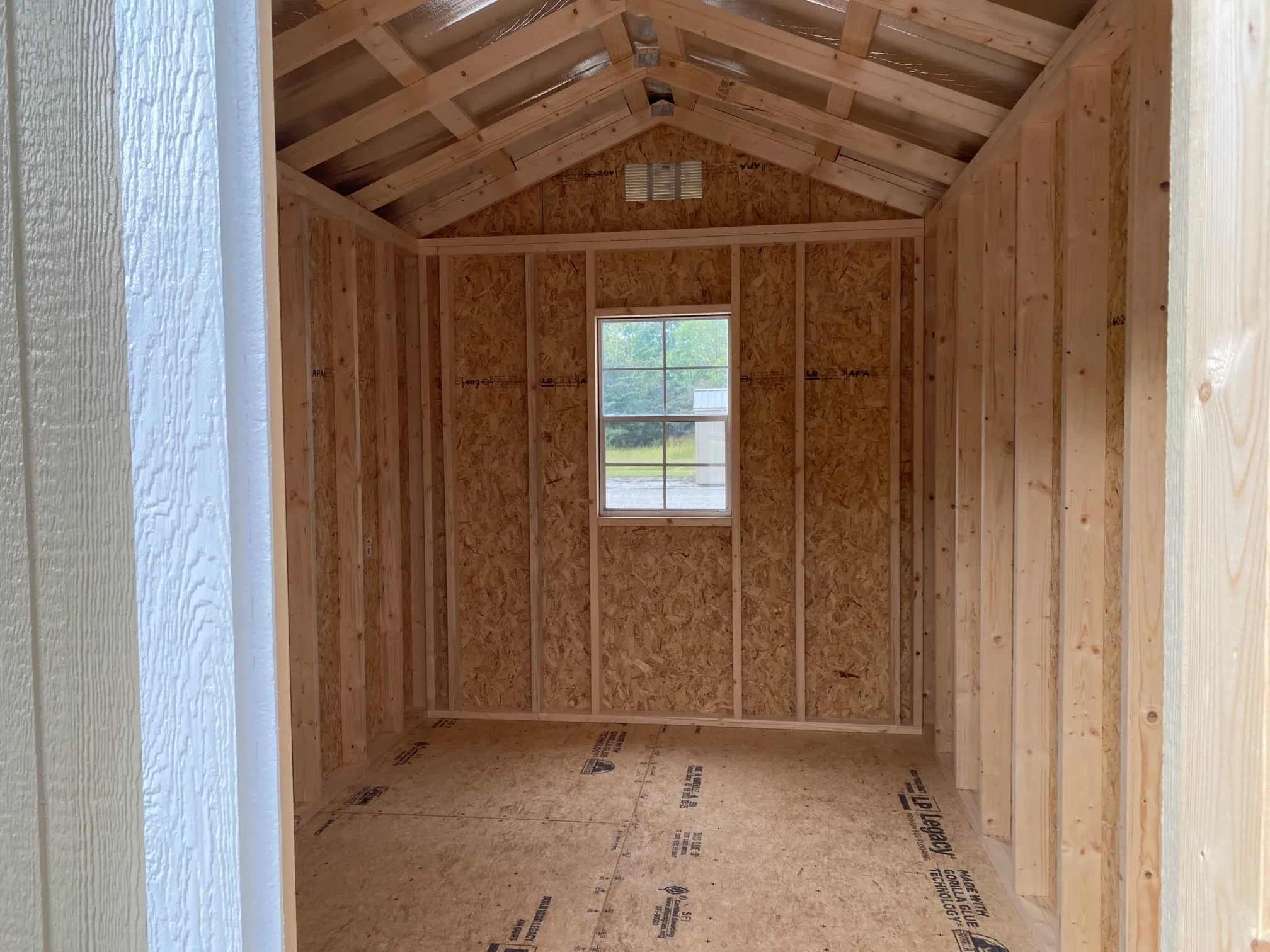 The inside of a shed showing a window in the back wall