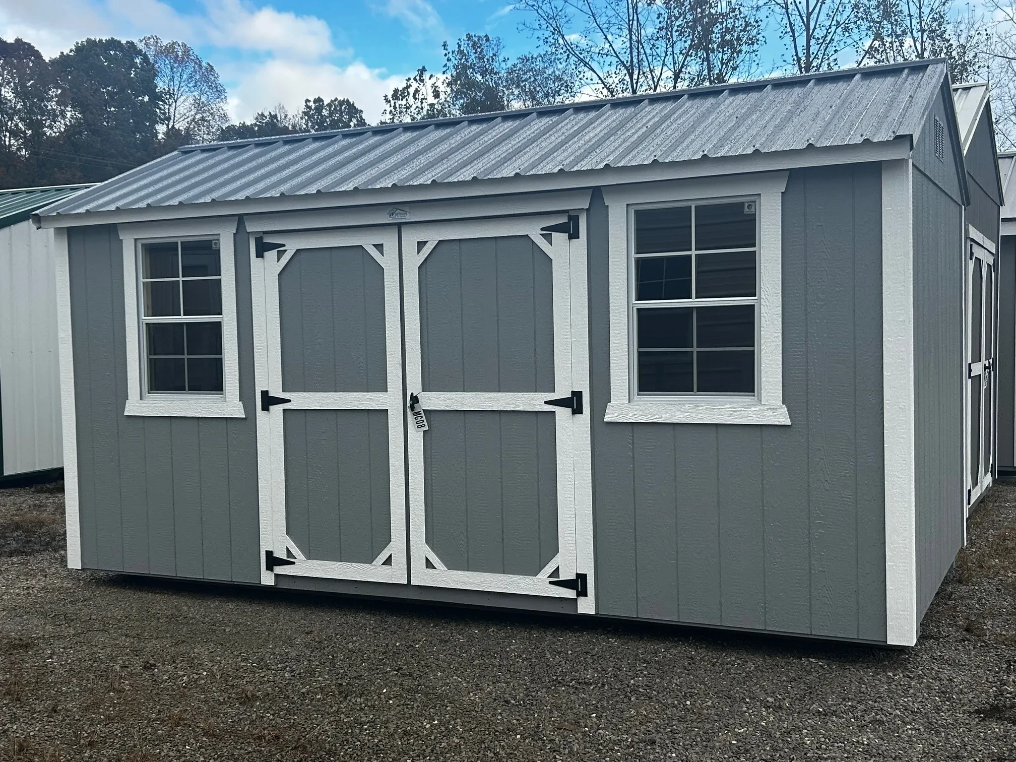 a gray garden shed with windows