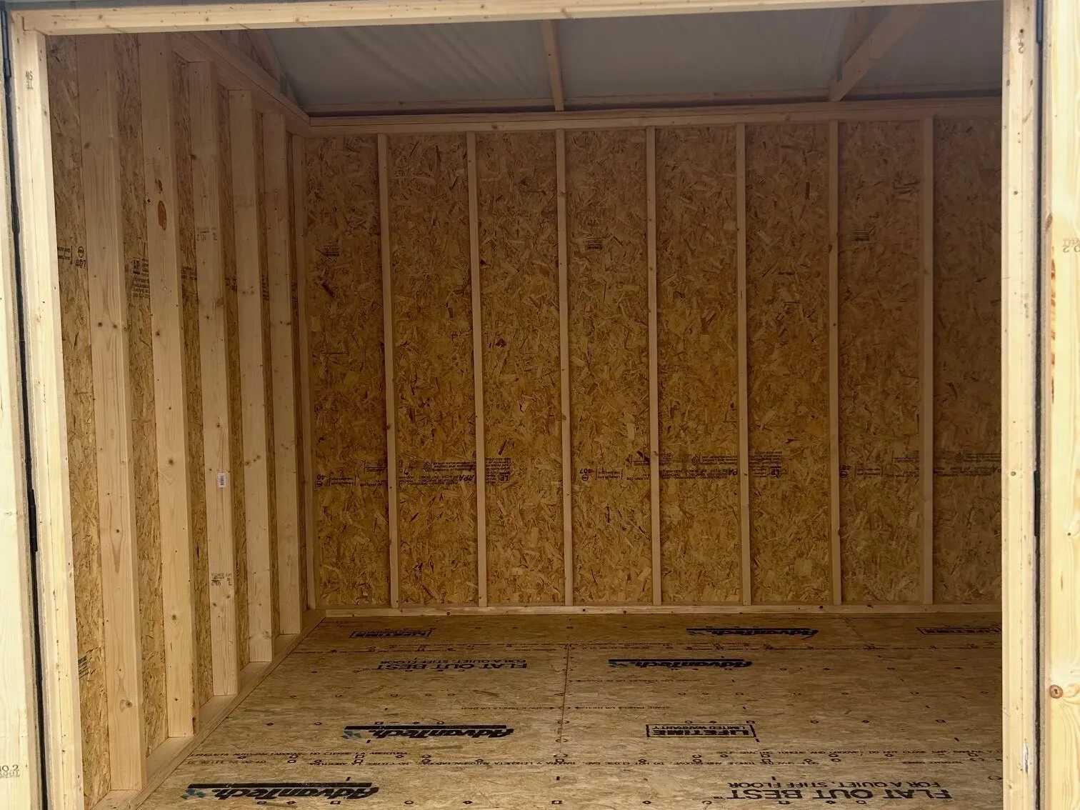 The inside of a wood shed showing the floor