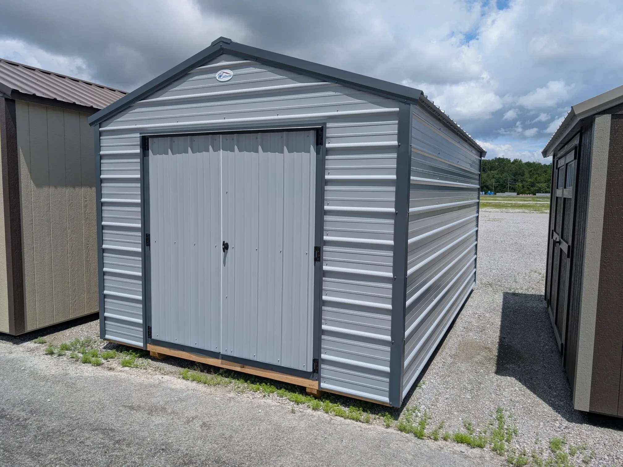 A gray metal shed with dark gray trim