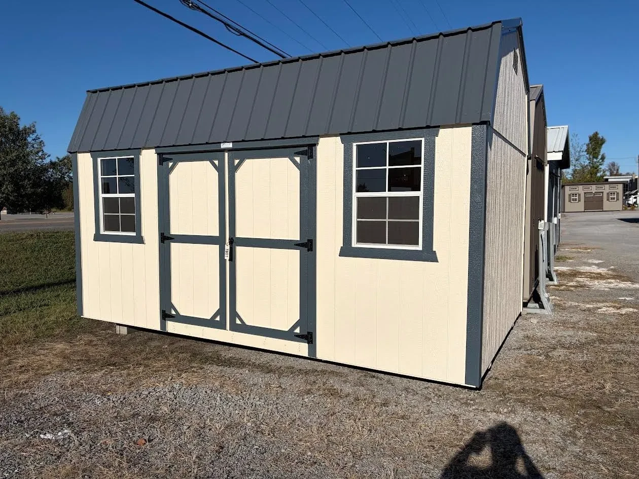side view of the wood side lofted barn navajo white siding with slate gray roof & trim
