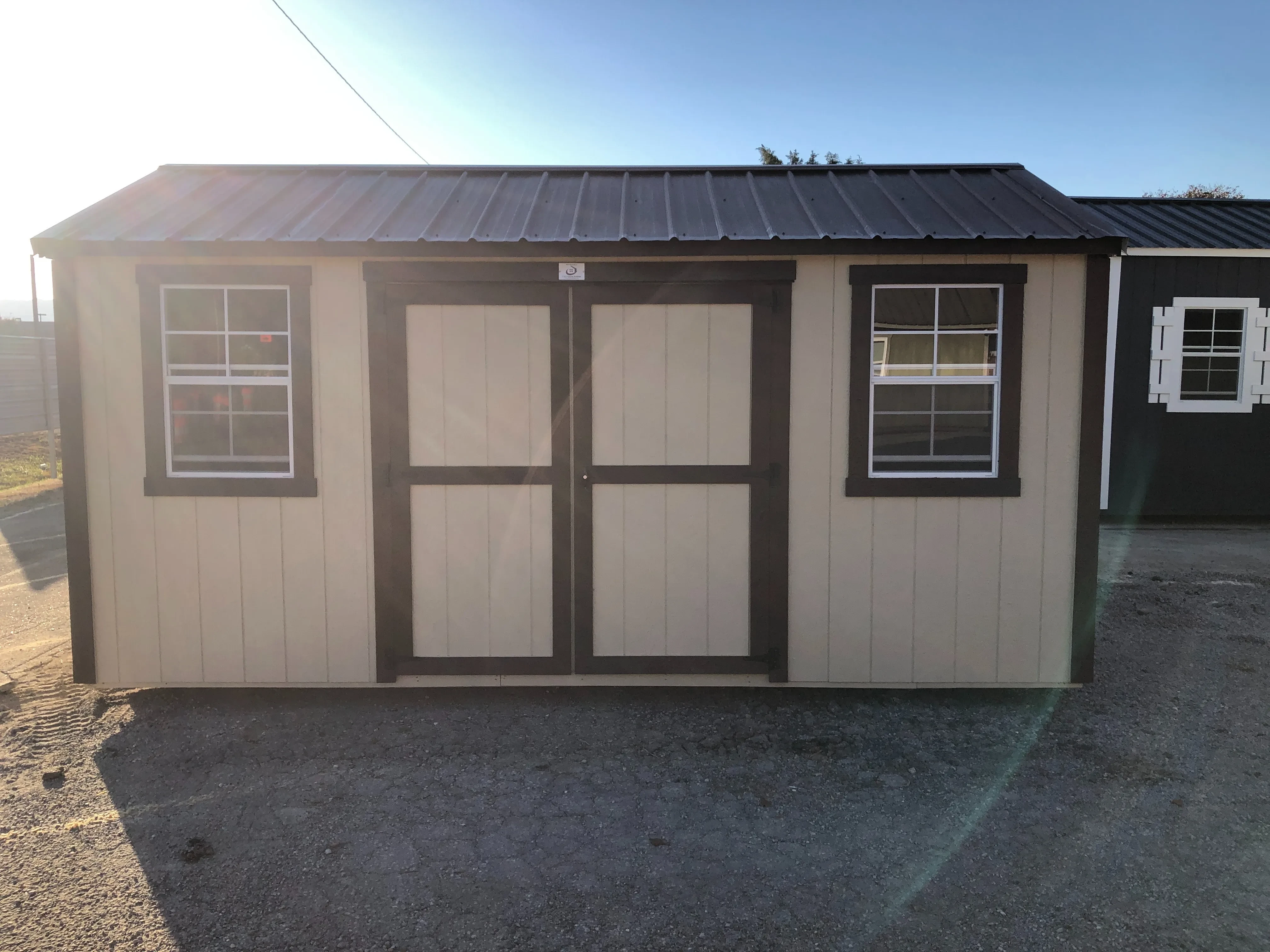 exterior of 8x16 garden shed showing double doors and 2 windows