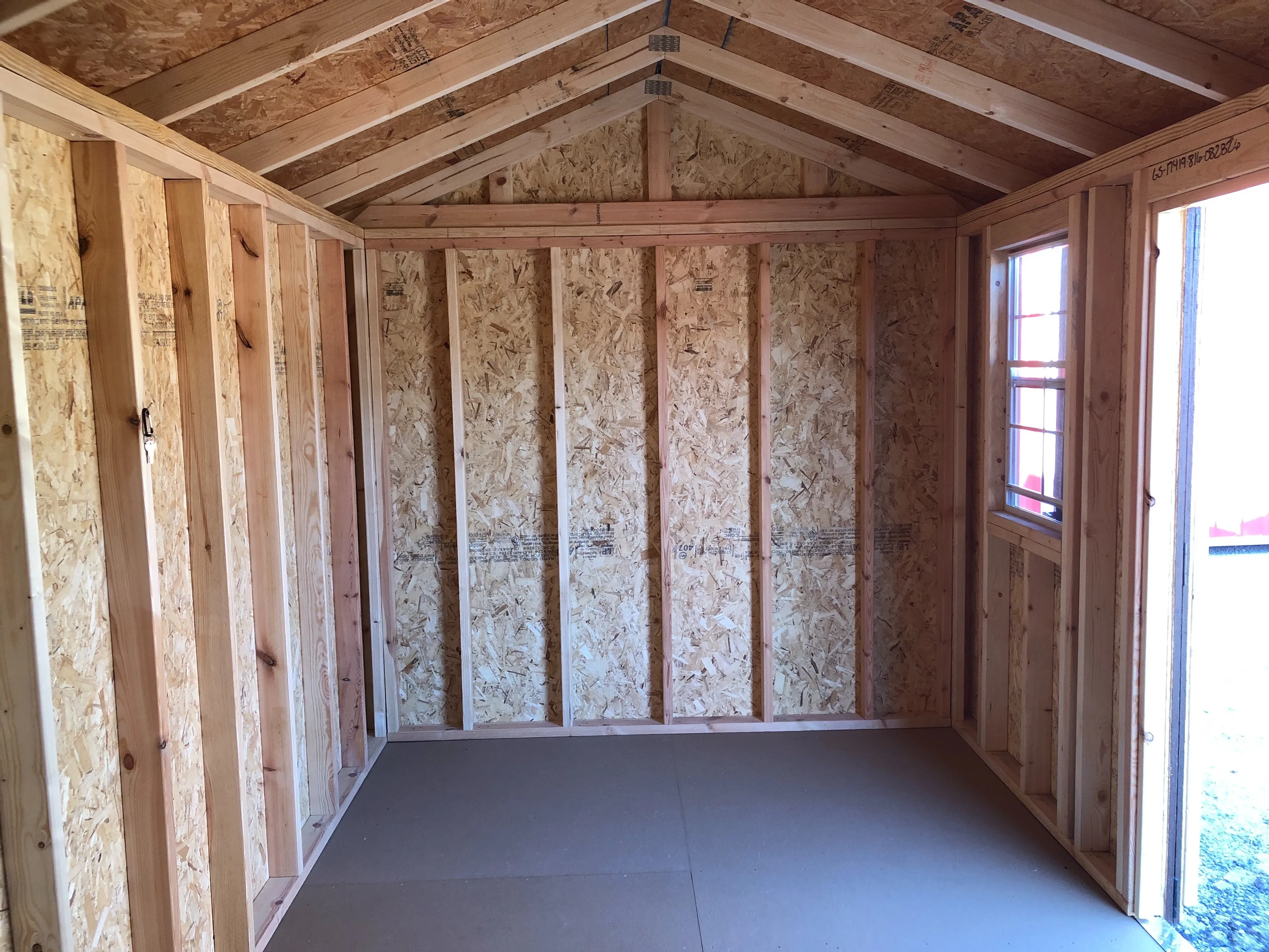 interior of 8x16 garden shed showing floor, window and part of doorway