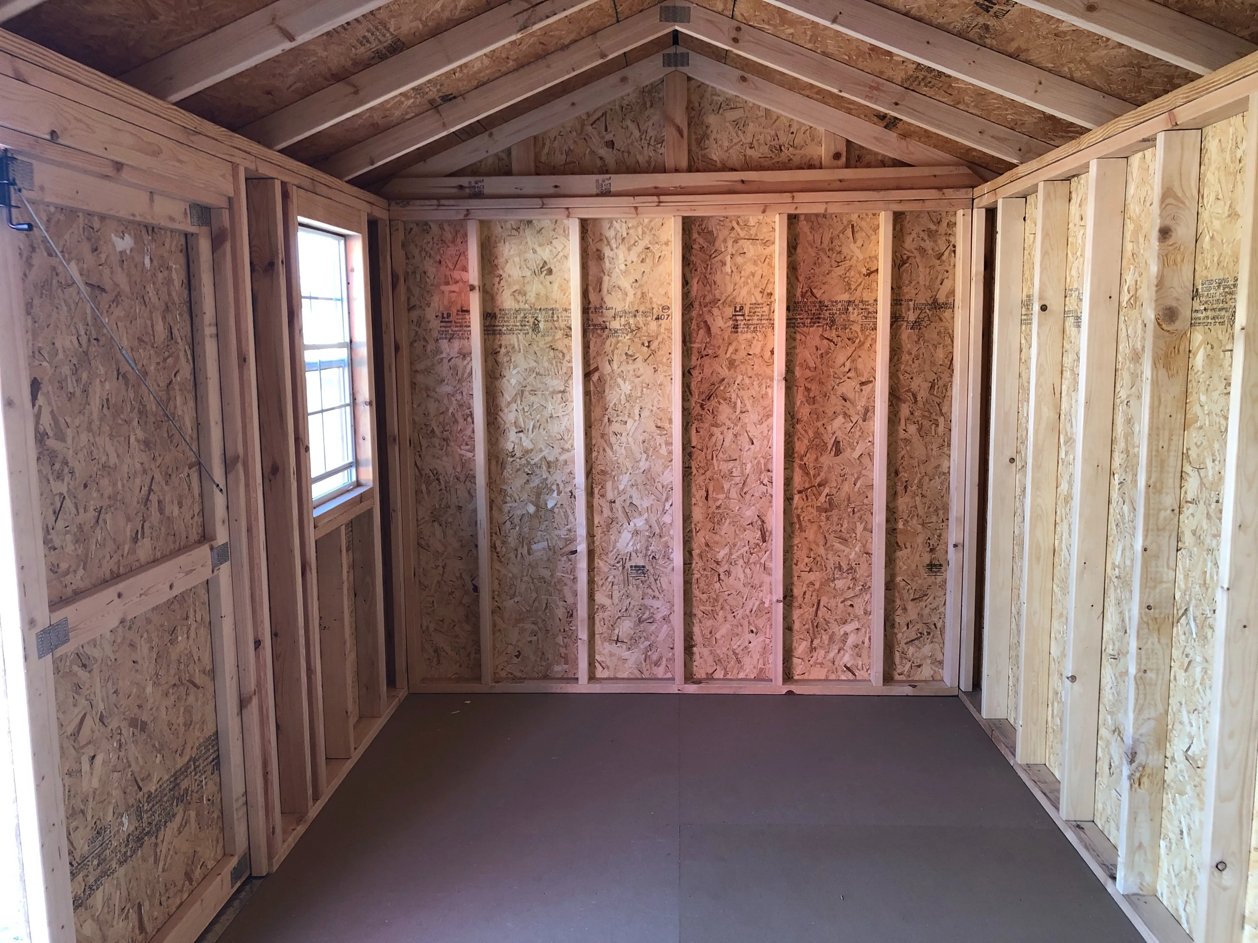 interior of 8x16 garden shed showing floor, window and part of doorway