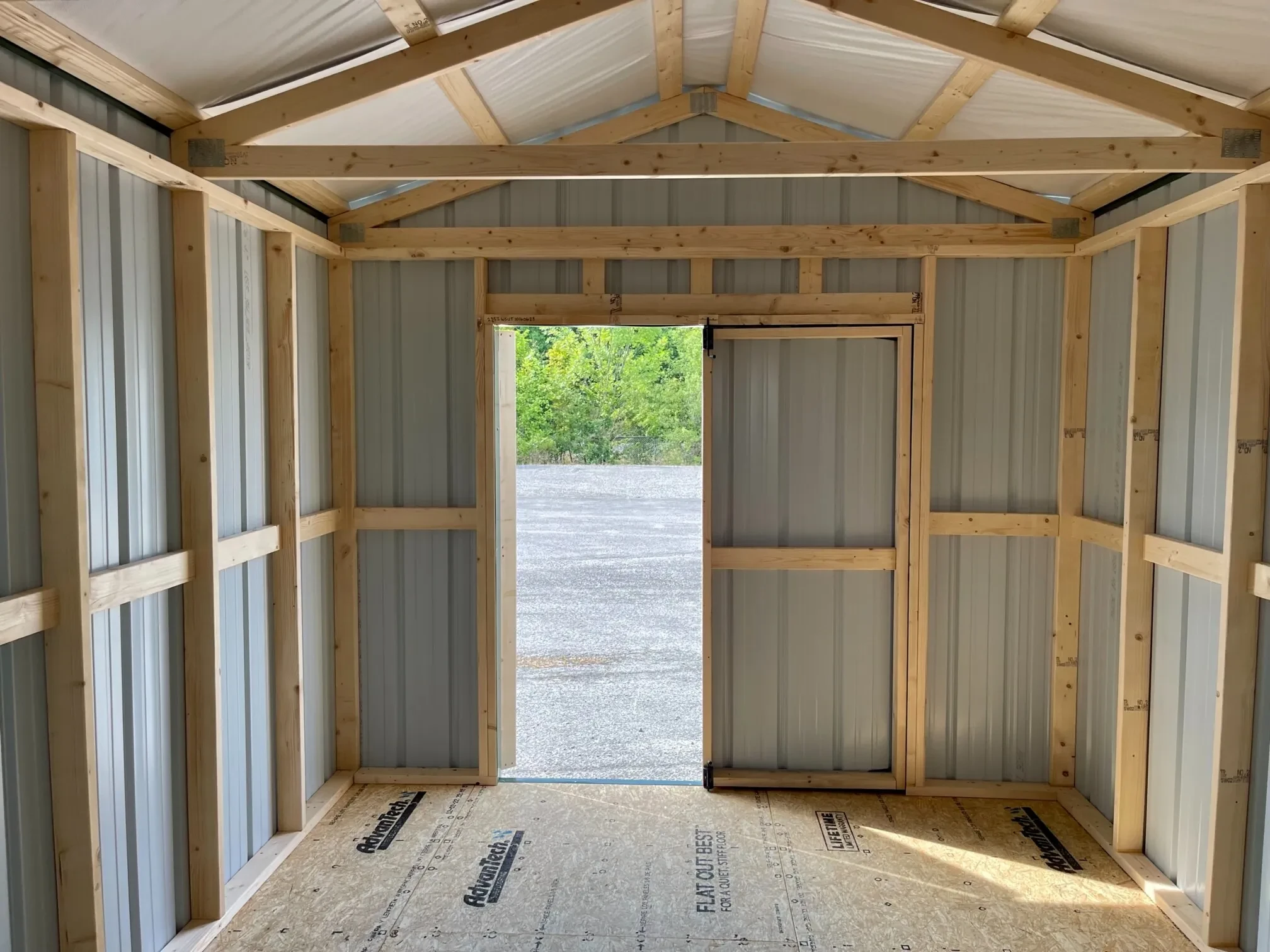 the inside of a metal shed showing the double doors open