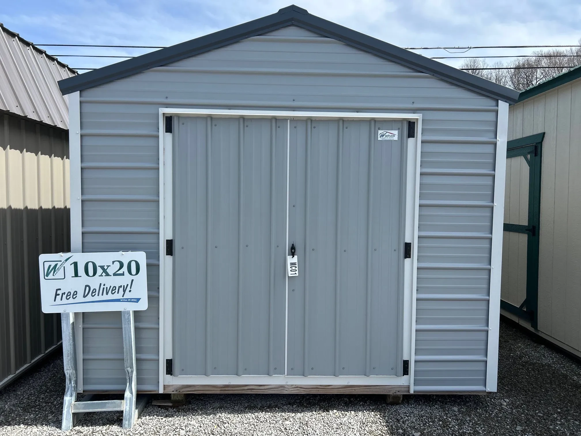 the front of a light gray metal shed
