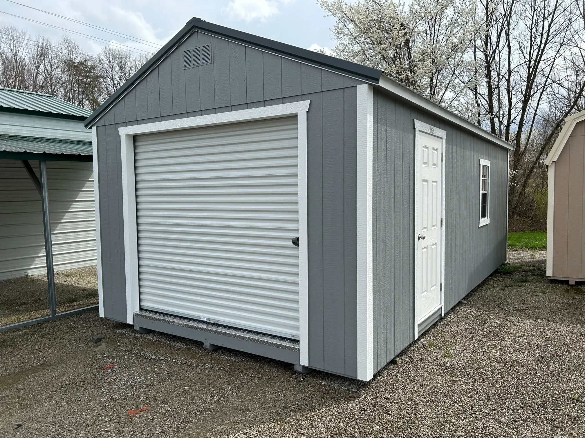 a garage shed with a walk in door a rollup garage door and a window