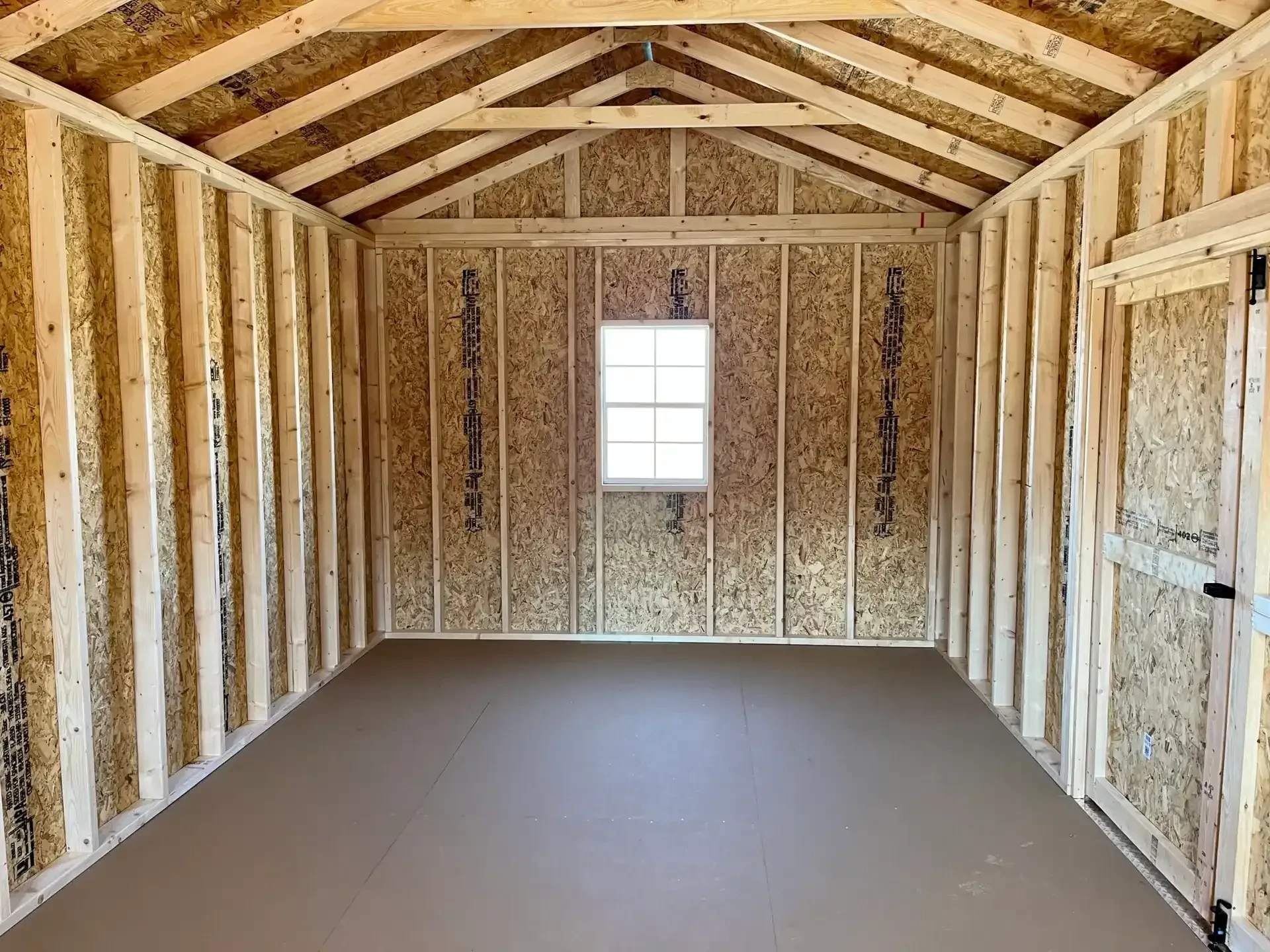 the inside of a cabin showing a window in the back wall and double doors on the side