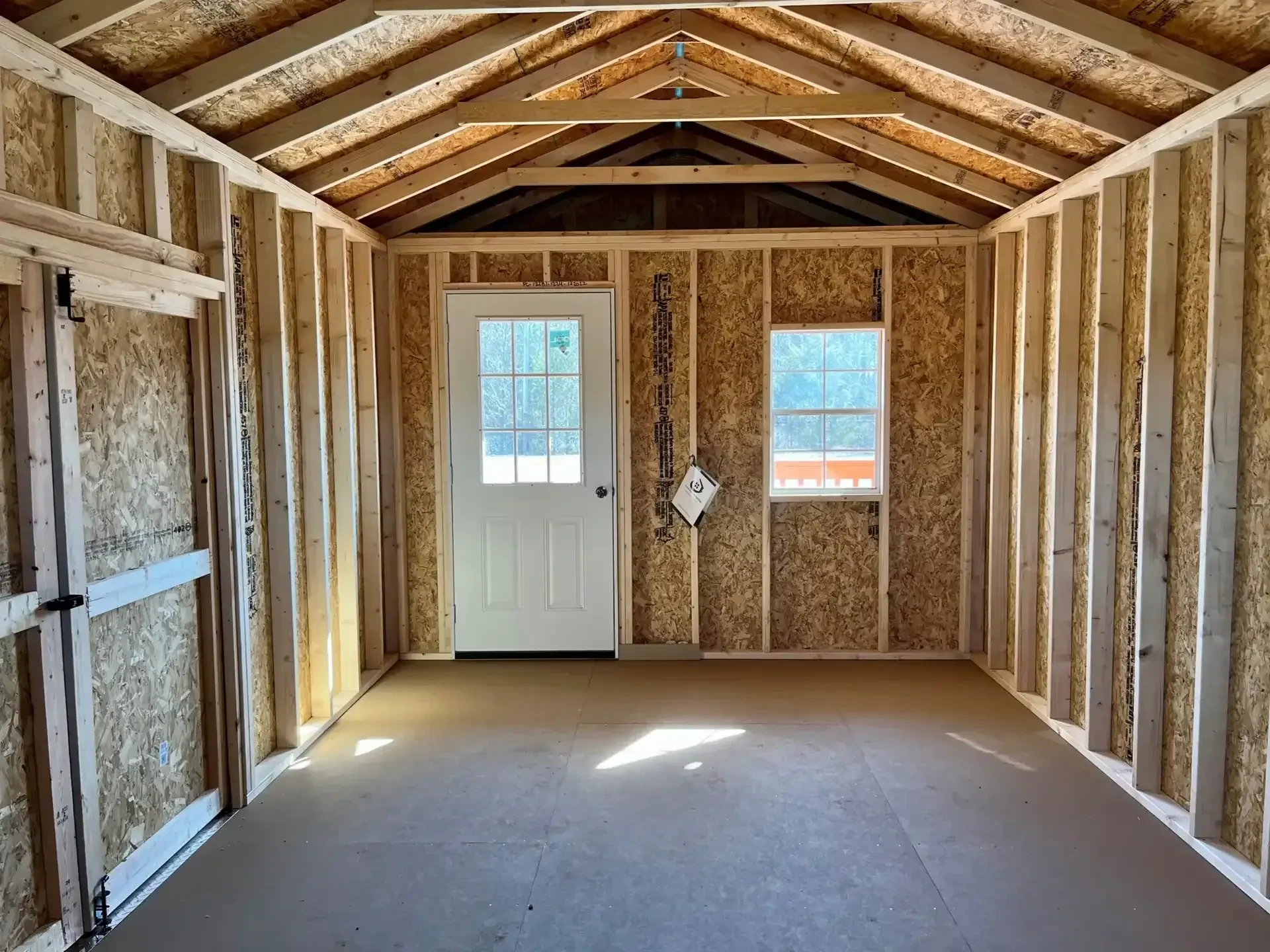 the inside of a cabin looking at the 9-lite walk in door and a window next to it
