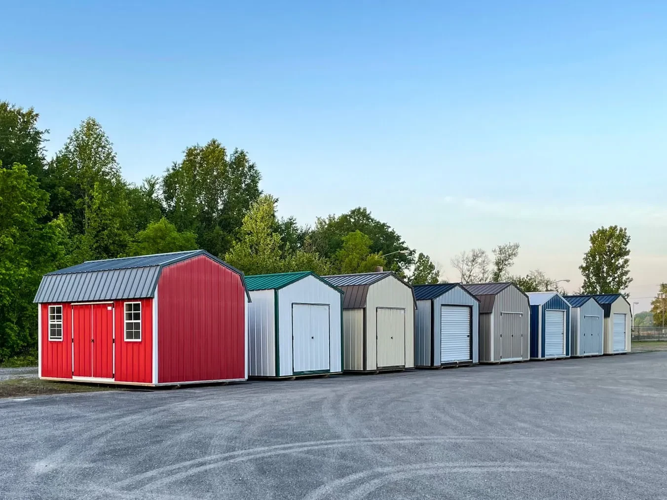Row of colorful metal sheds on a gravel lot