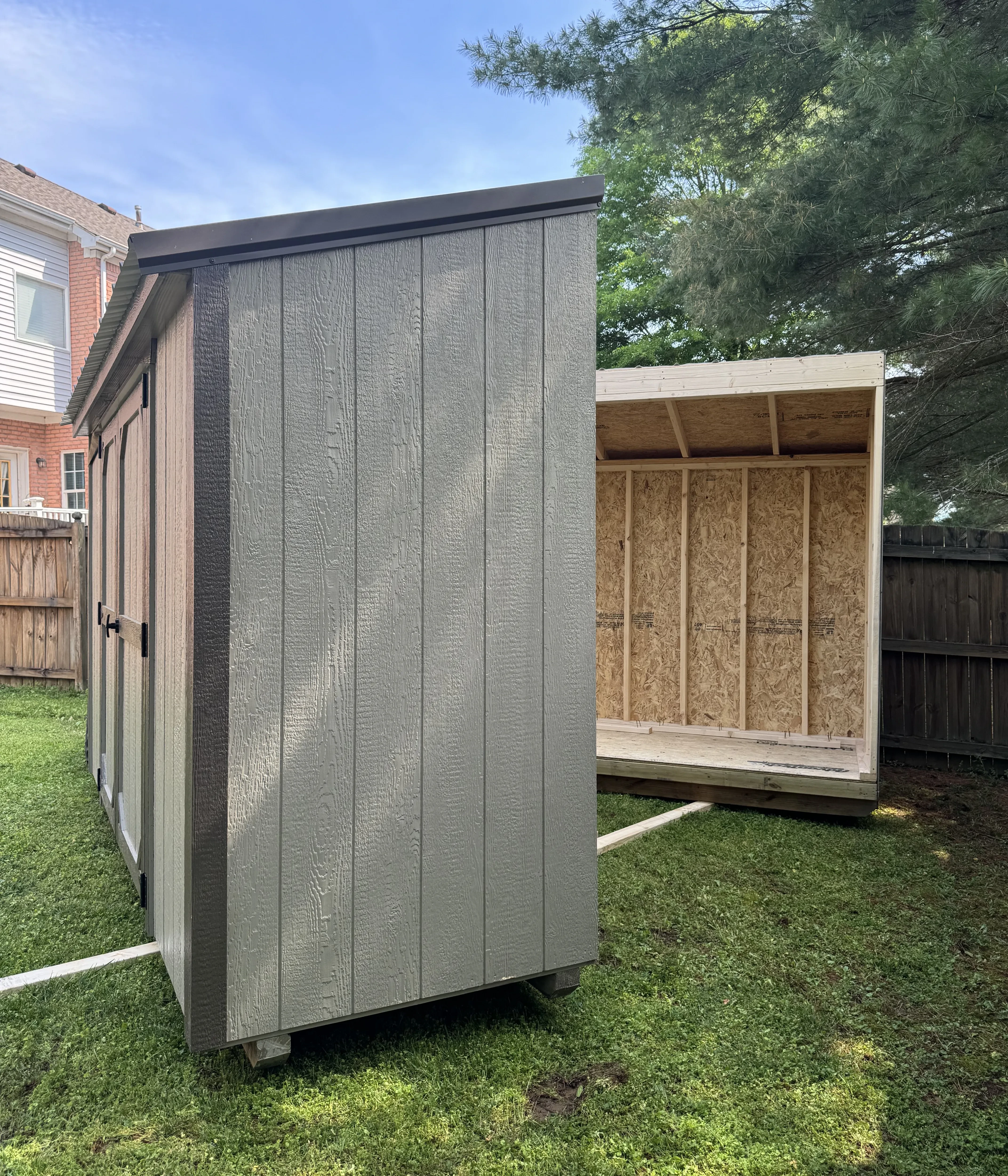 Second half of a shed ready to be put together with the first half.