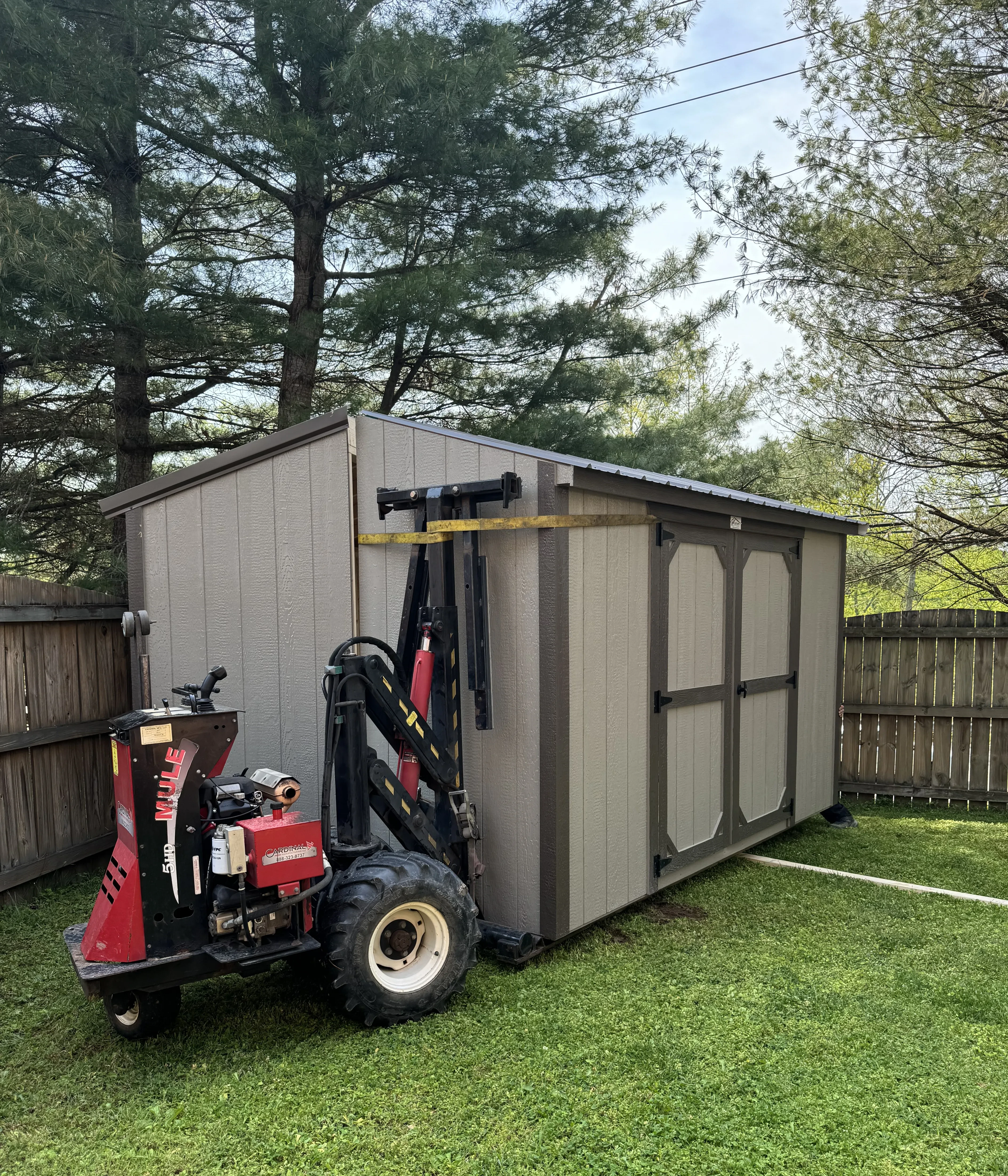 Using a mule to set the second half of a shed.