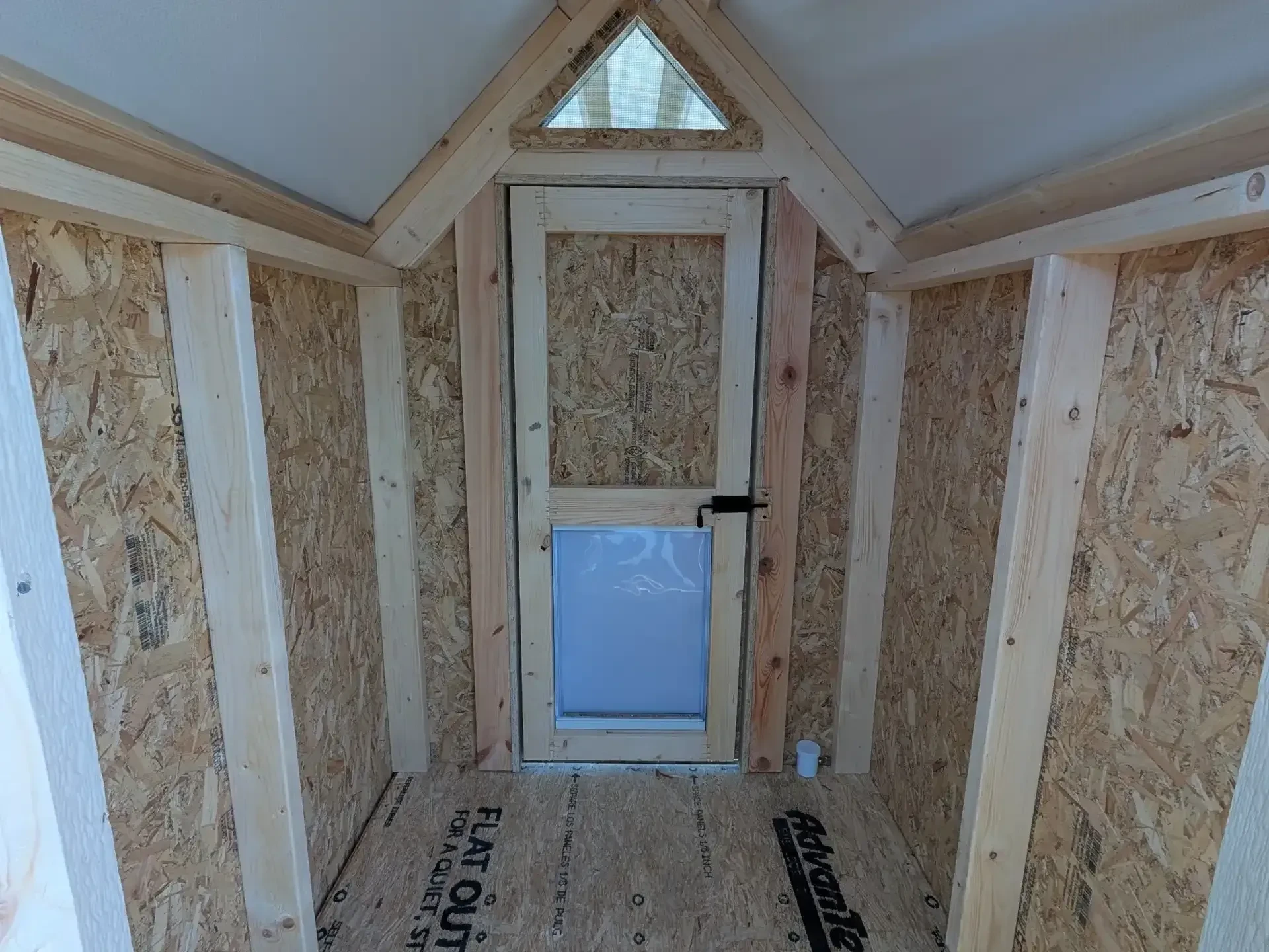 the inside of a dog kennel showing a walk-in door