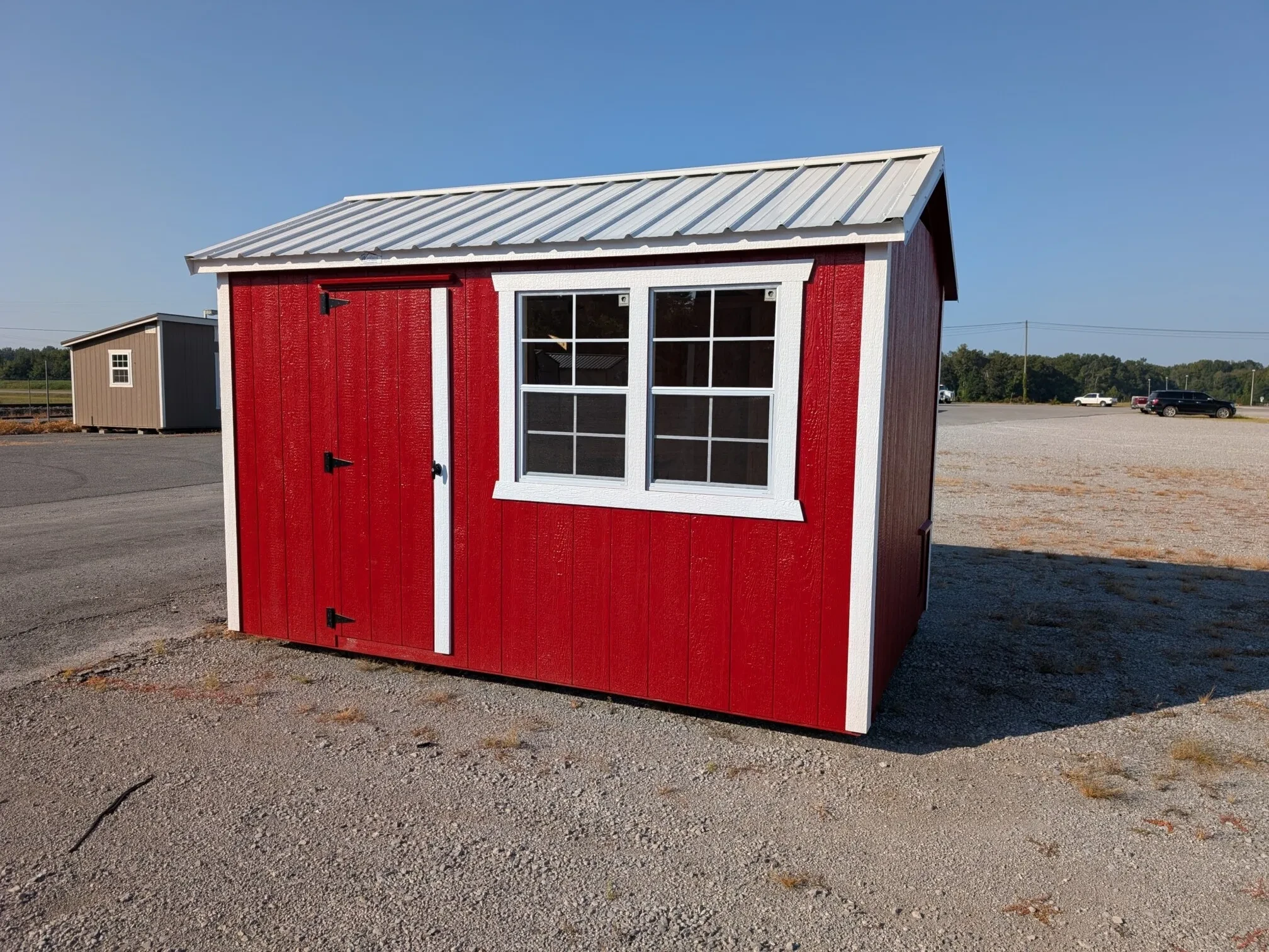 A red chicken with white trim and two windows next to each other